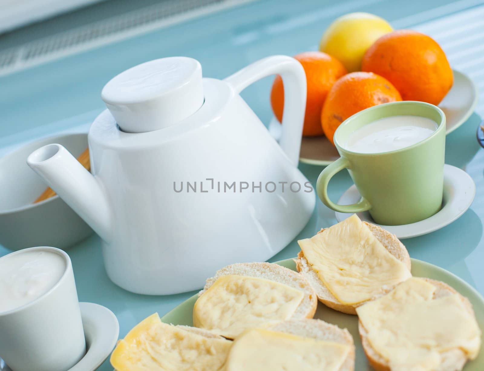 Early health breakfast - milk and cheese, a healthy eating on white plate and cup
