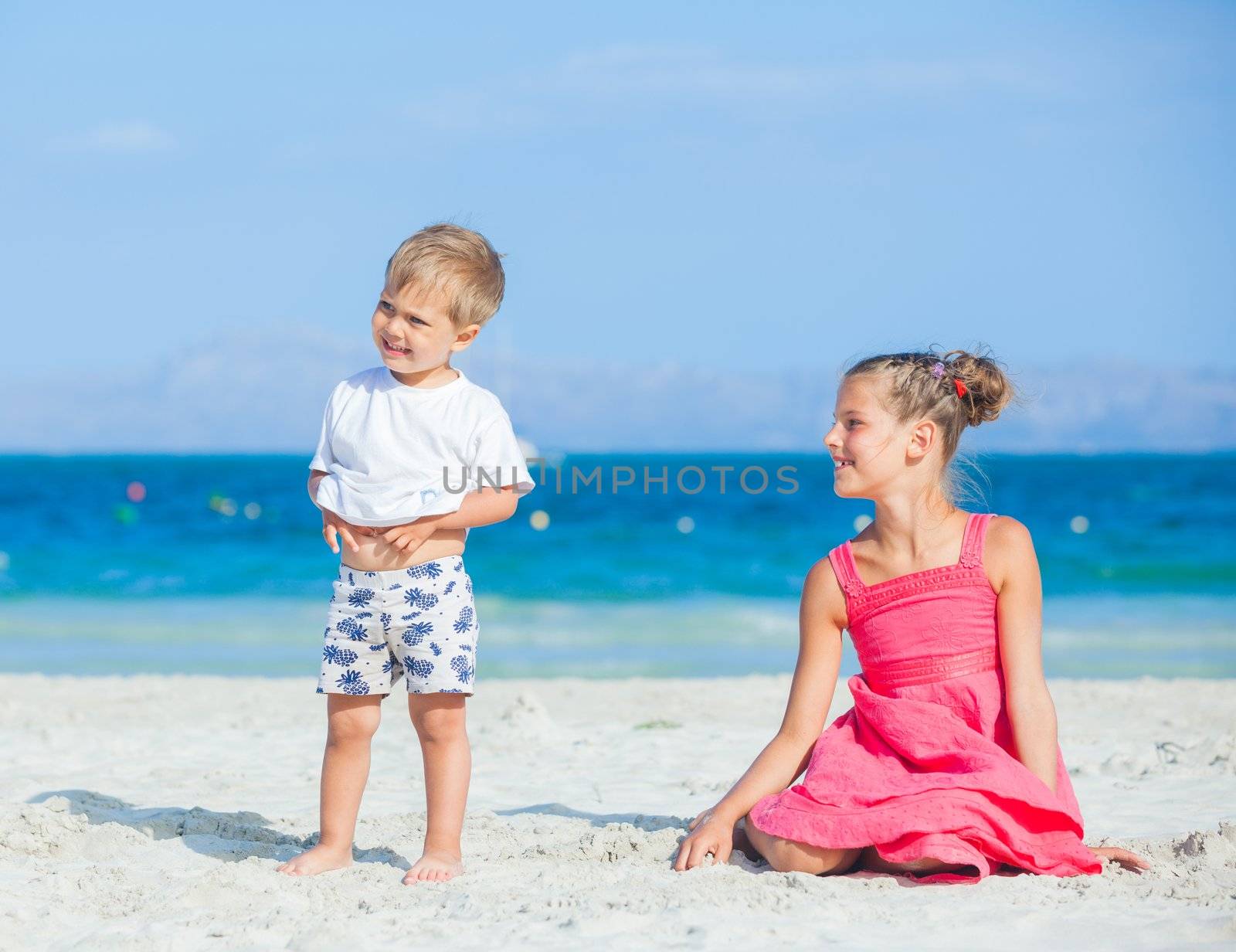 Boy with his sister walking on jetty by maxoliki