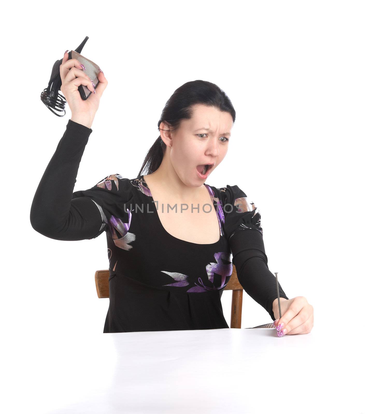 The girl hammers in nail a shoe on  white background