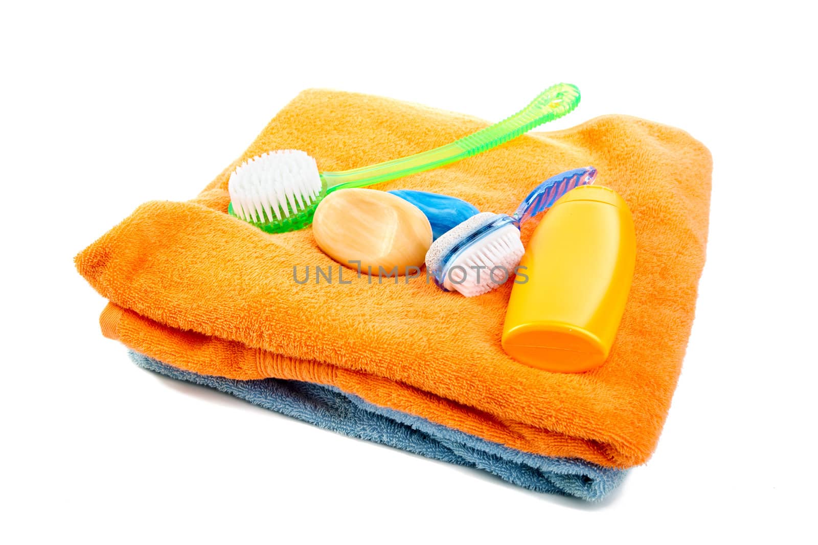 Washed shampoo bath towel and brushes on a white background