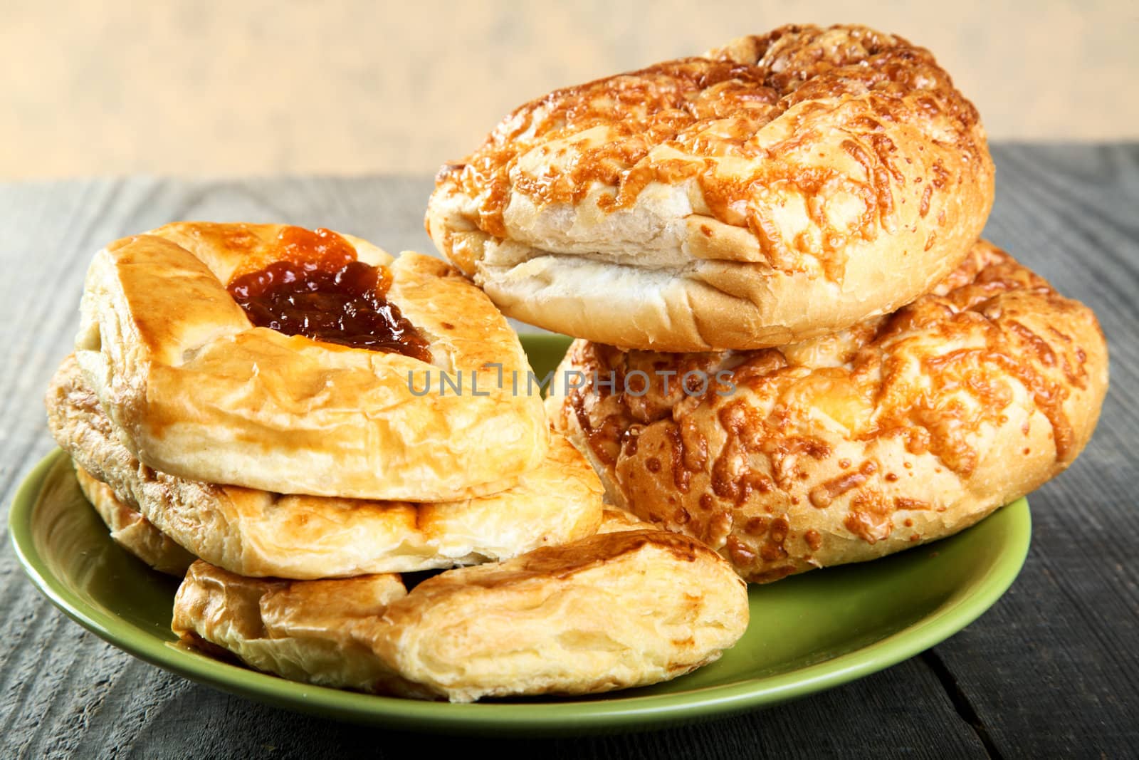 Rolls and bread on a wooden table unplaned boards
