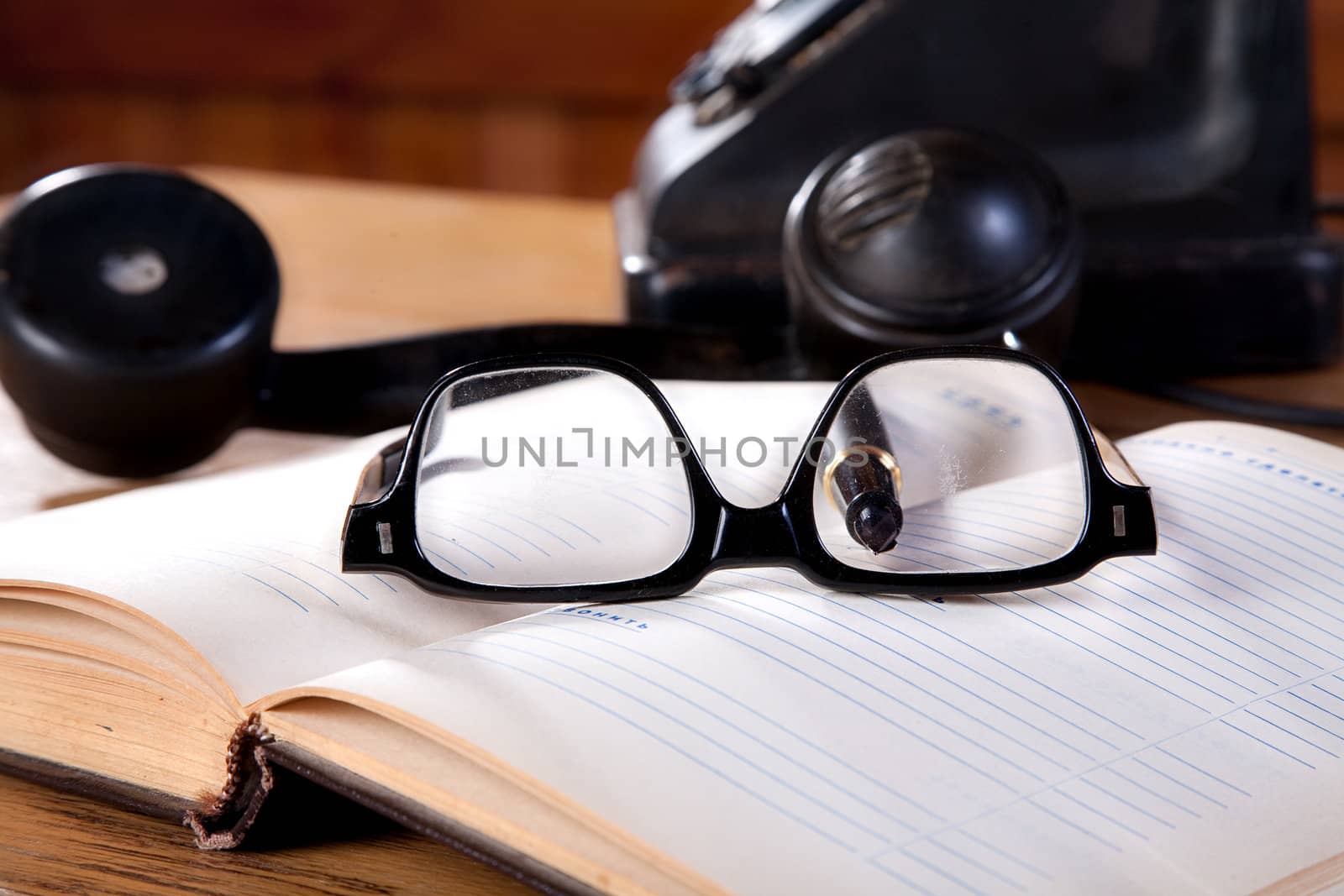 The old daily log with glasses and phone on a table