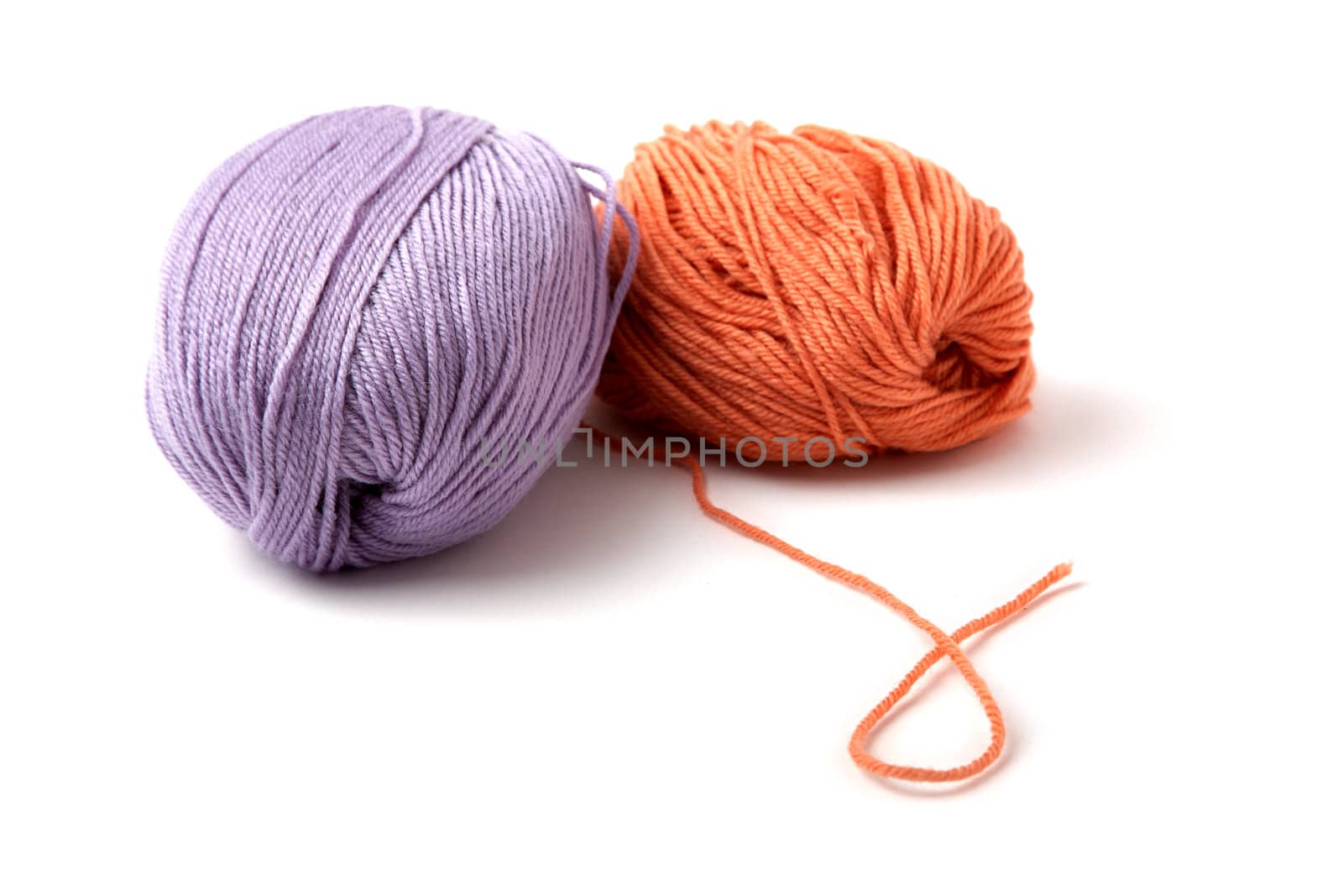 Balls of a multi-coloured yarn on  white background