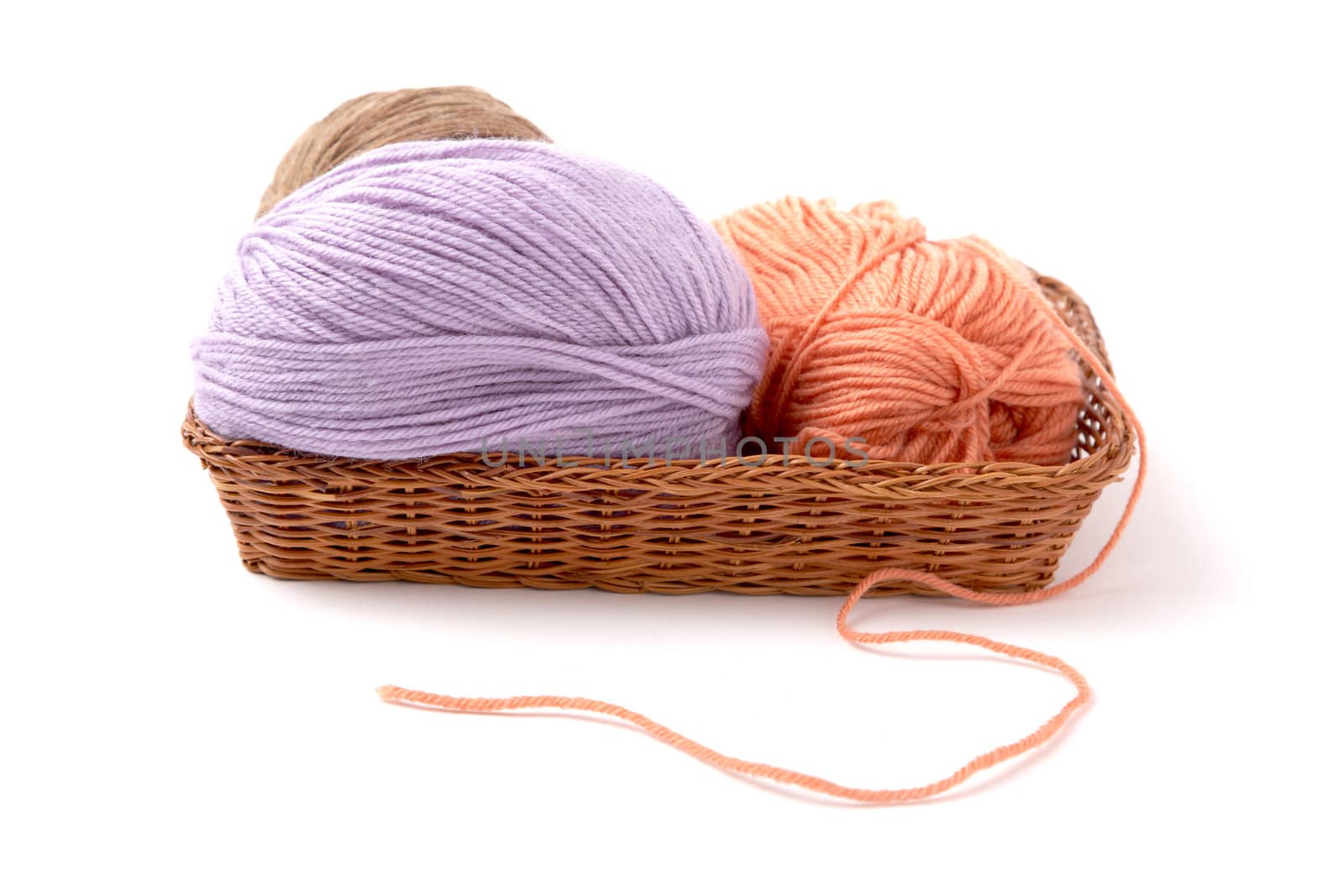 Balls of a yarn knitting in wooden box on white background