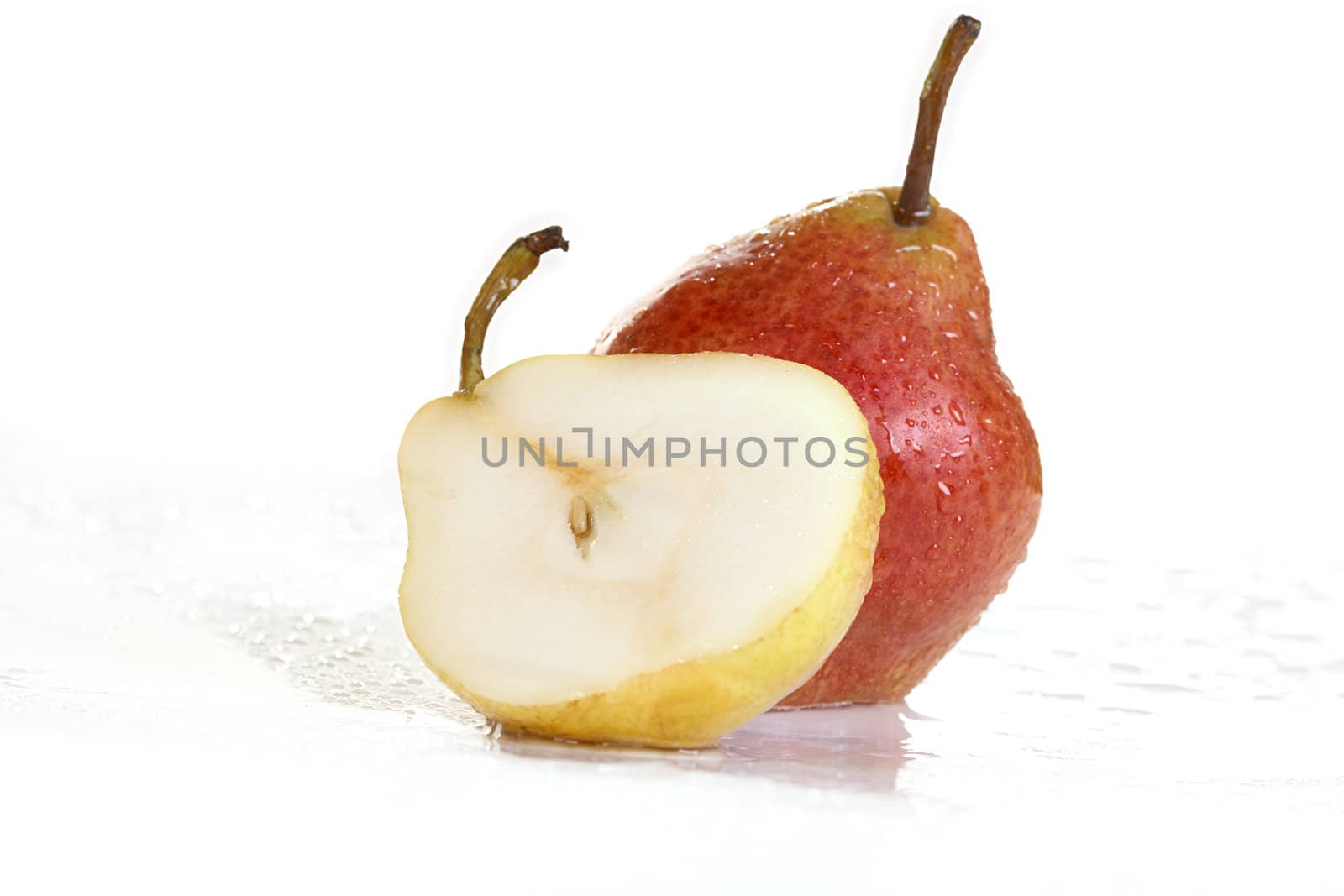 Pears with drops of water on a wet surface