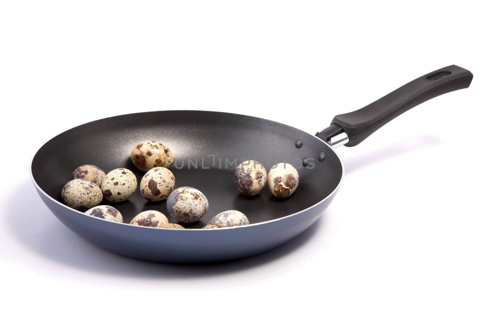 Frying pan with quail eggs on a white background