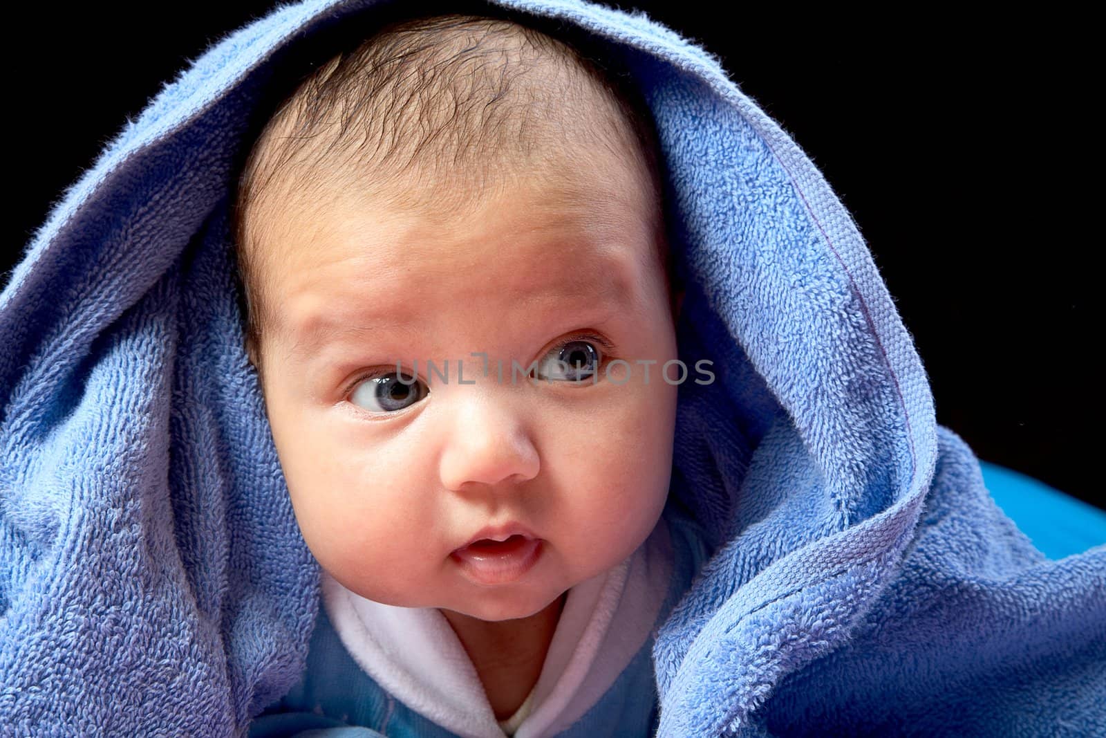 The baby close up on a black background