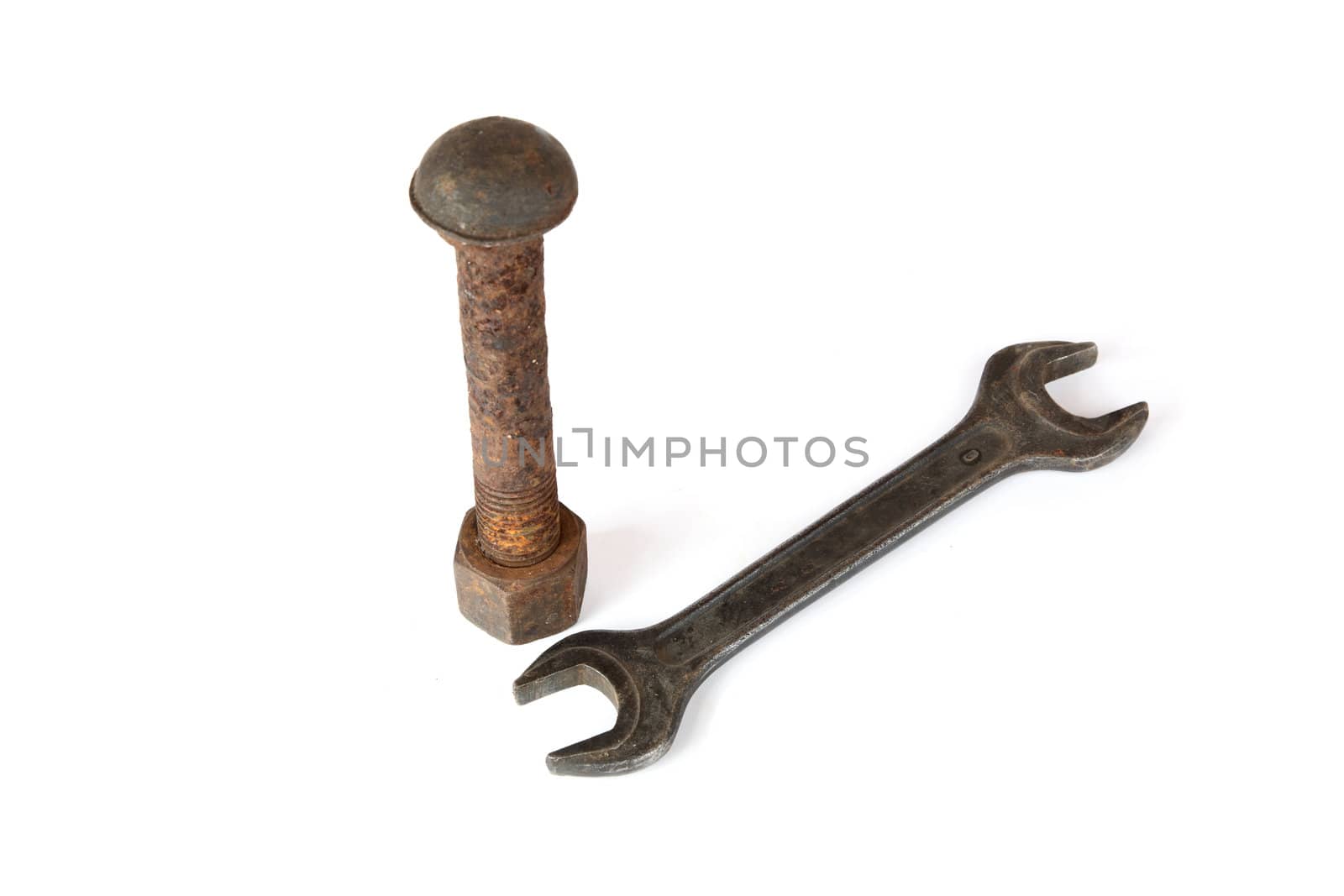 Wrench and rusty bolt with nut on a white background