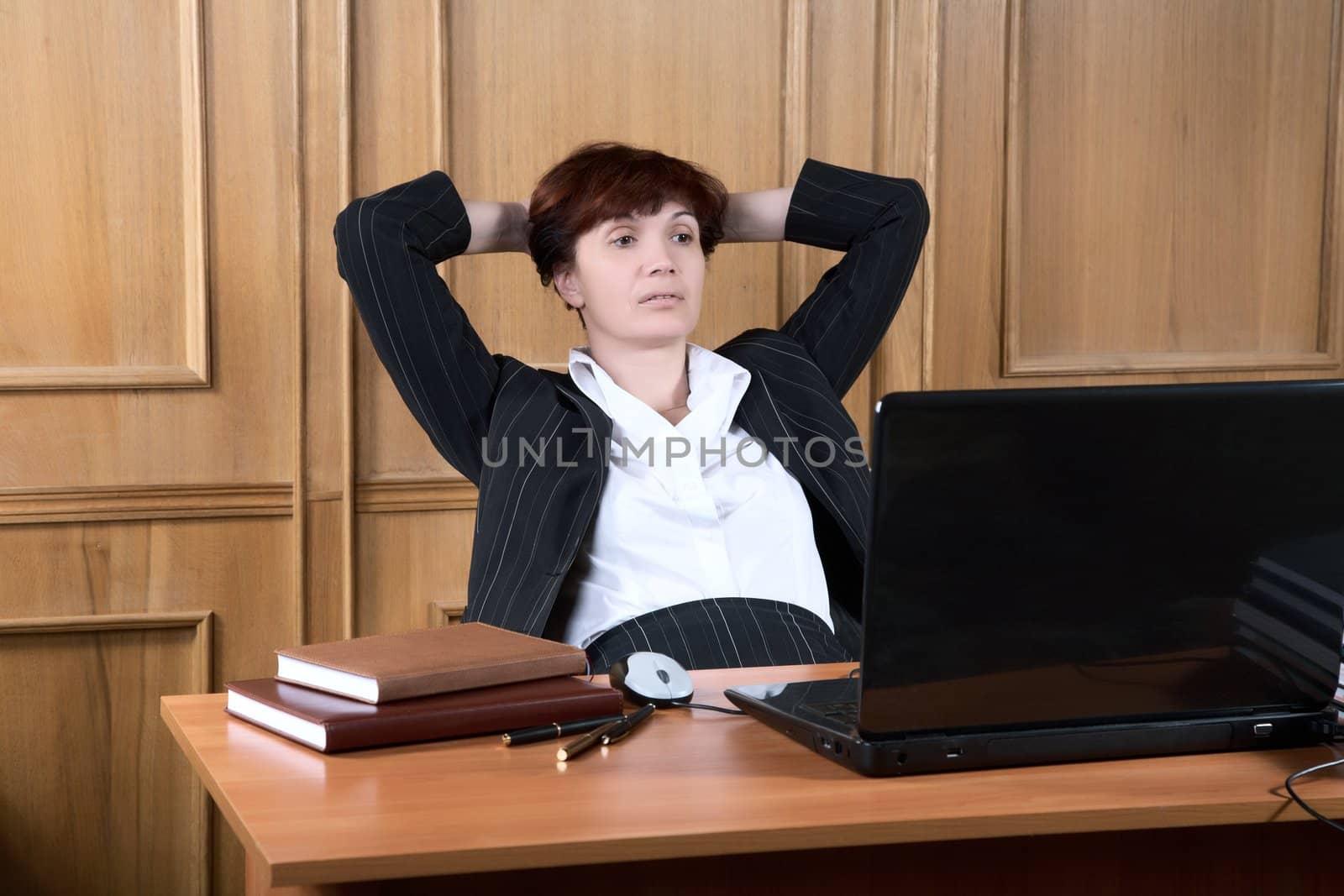 The business woman has made  break in work behind a table