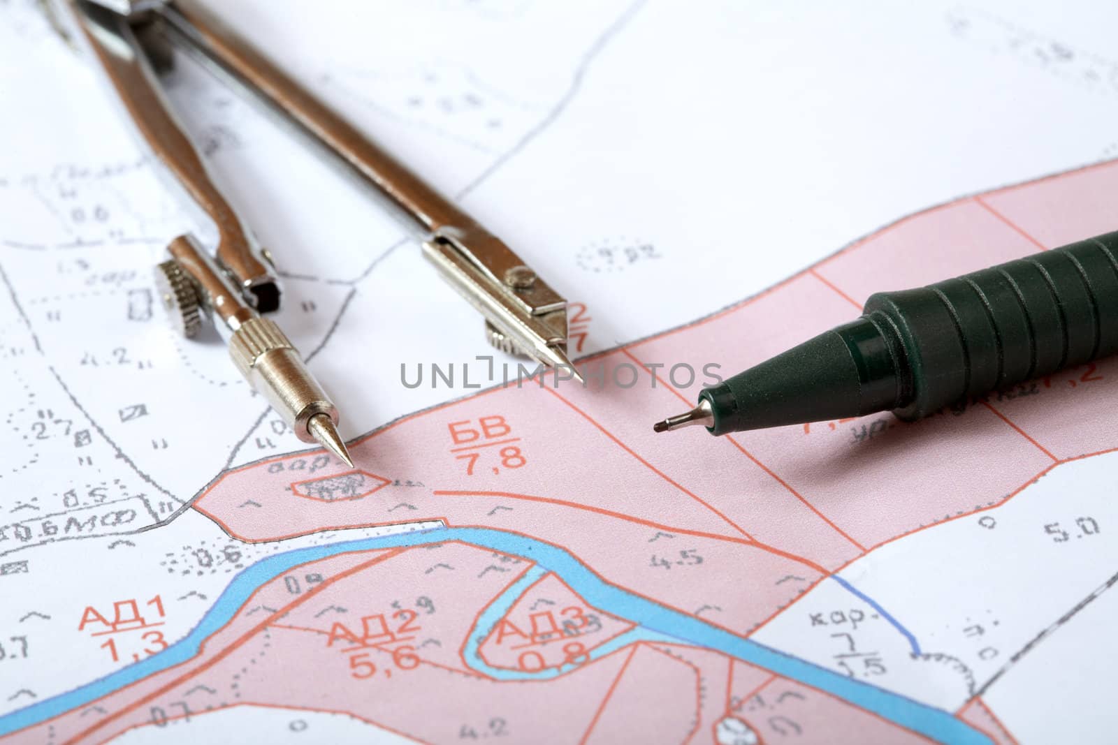 Topographic map of district with  measuring instrument,  ruler and a pencil