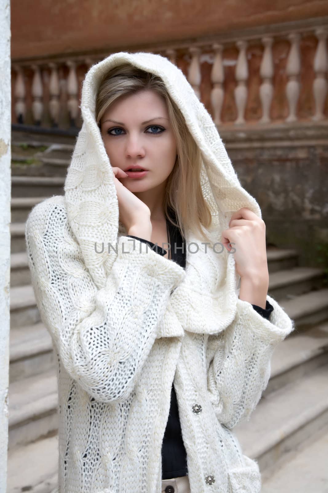 girl the blonde against a stone ladder