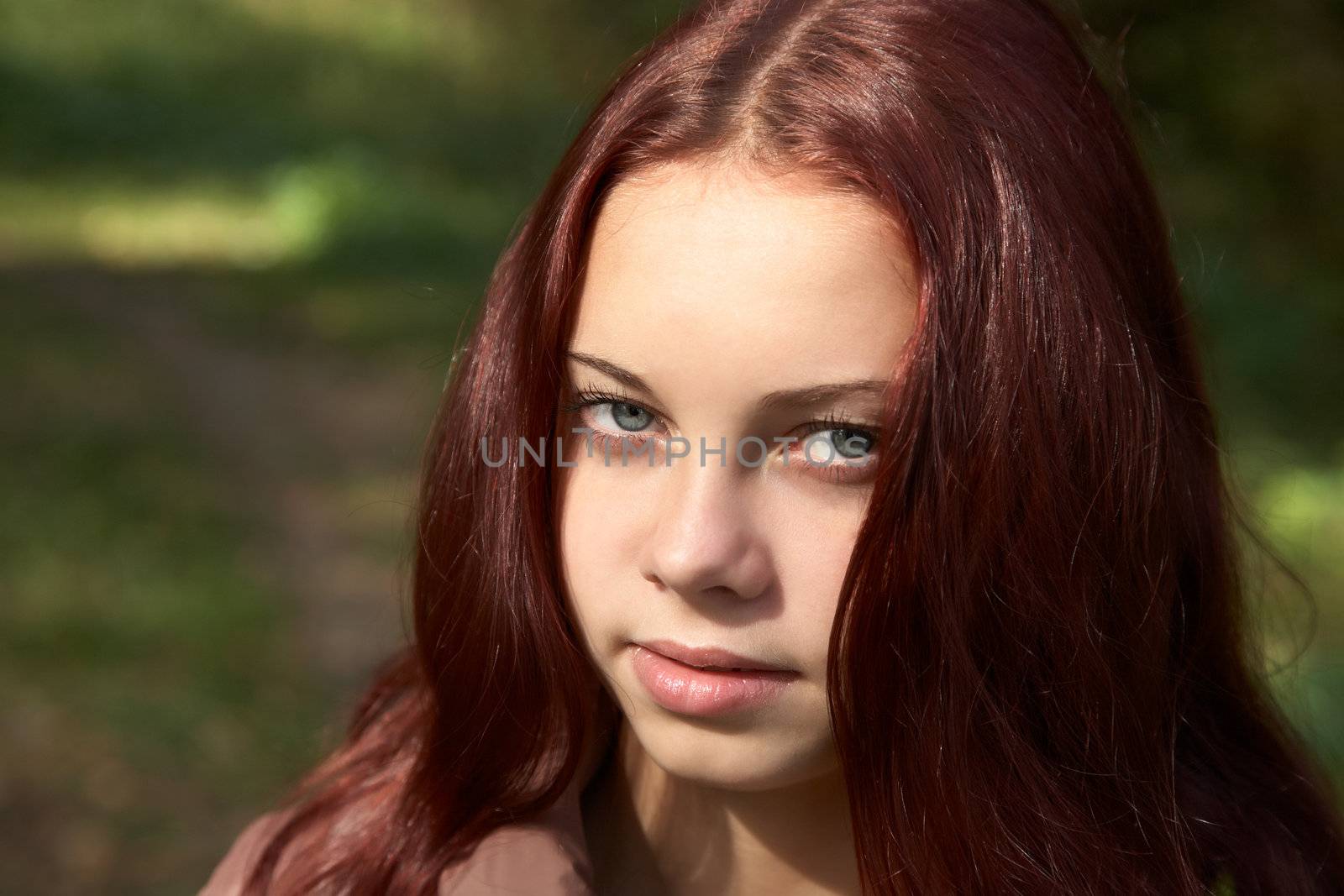 Portrait of the girl-teenager in the solar autumn afternoon
