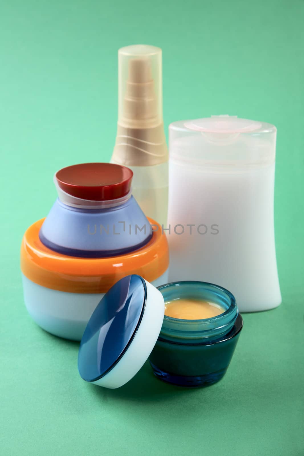 Tubes with  cosmetic cream on a green background