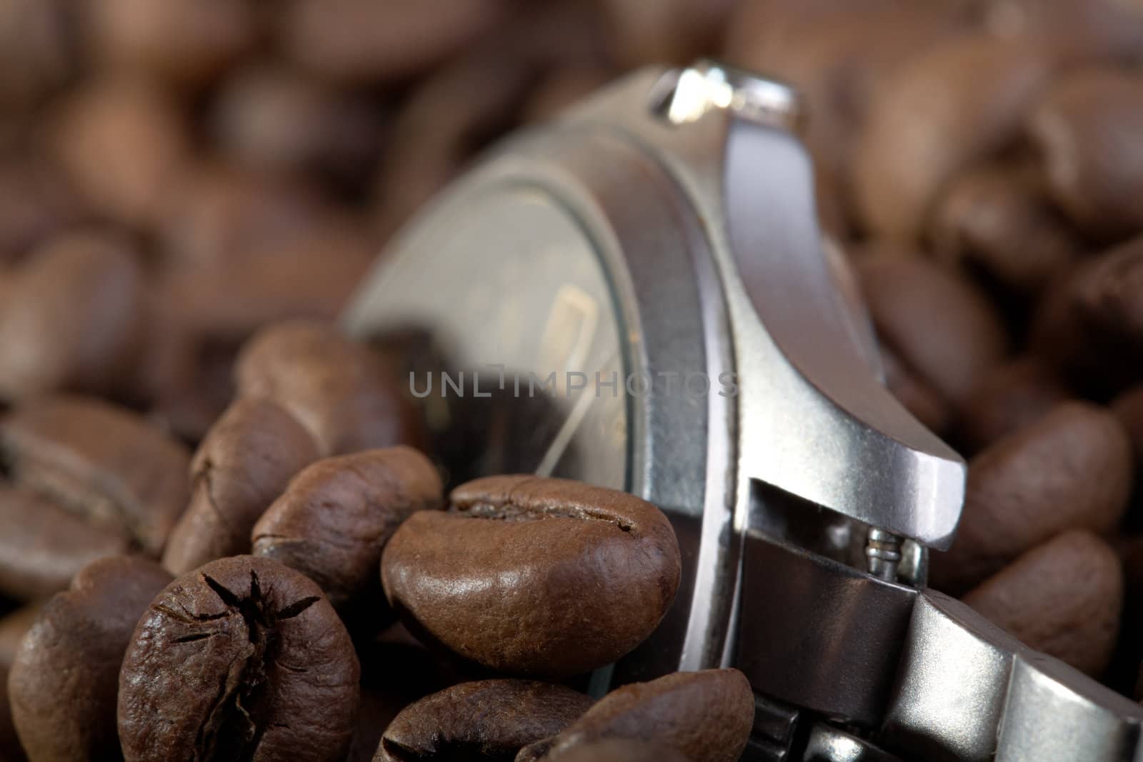 Watch in a heap coffee grains macro