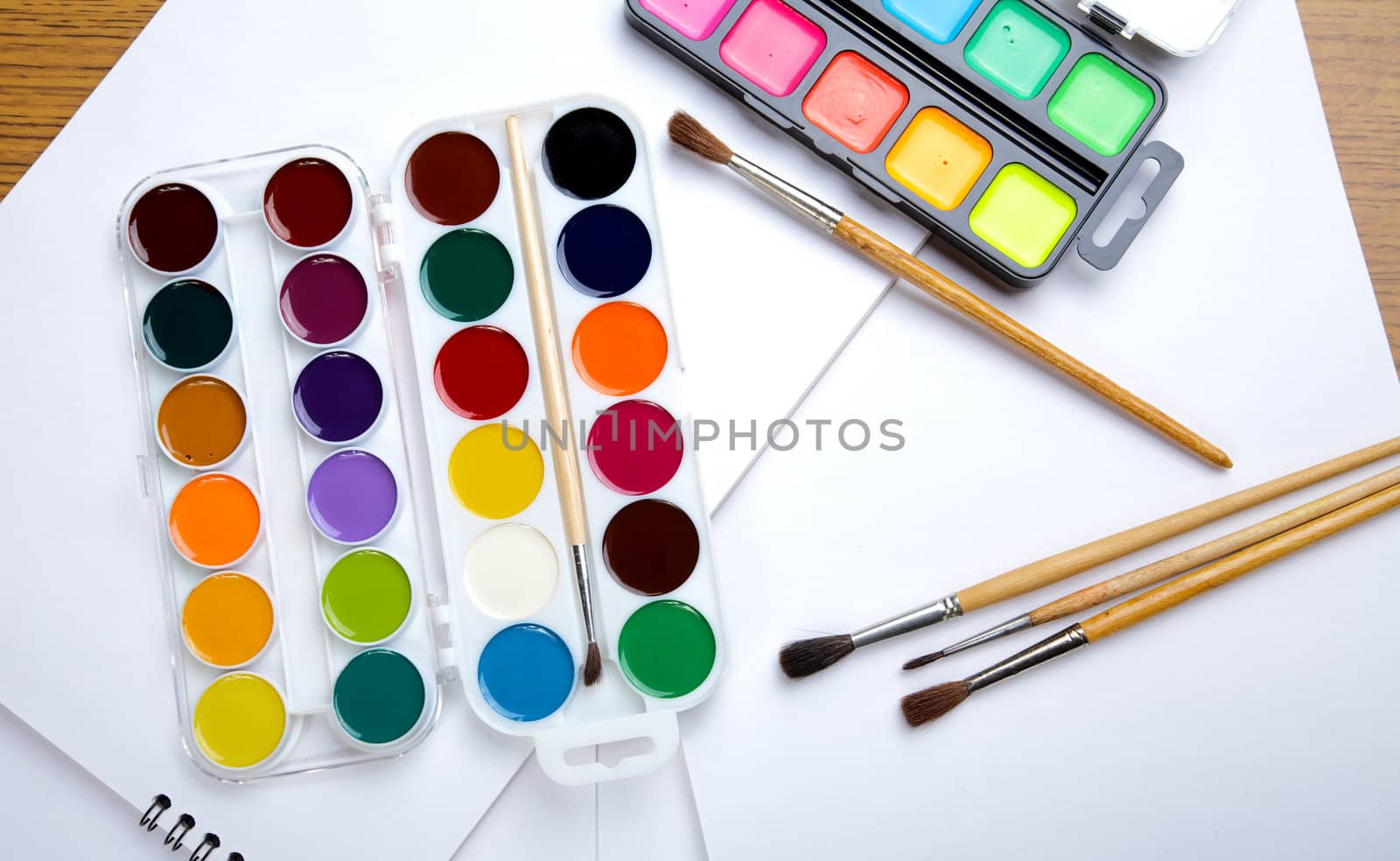 Water colour paints  brush albums for drawing on a table