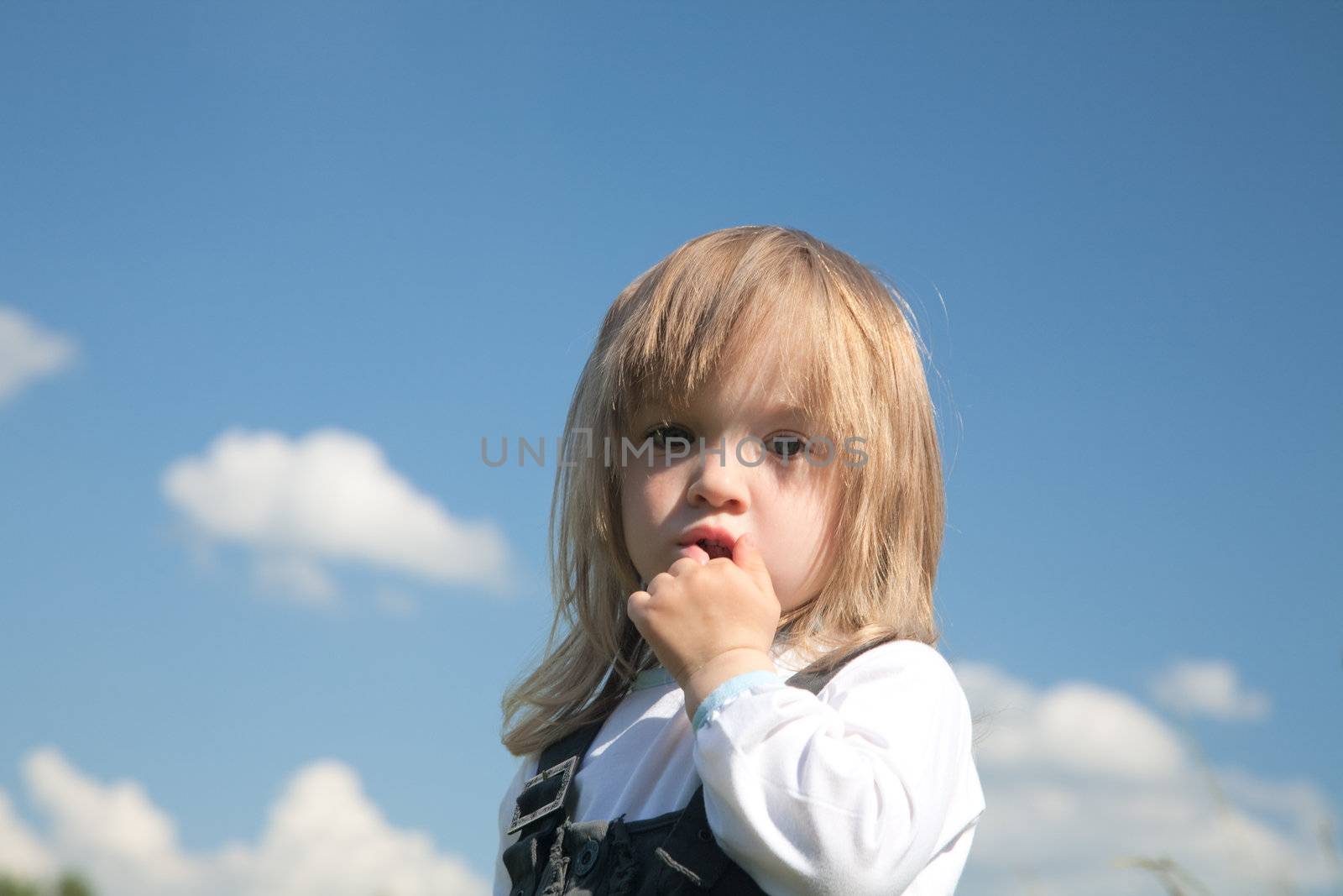  little girl on a background of the blue sky