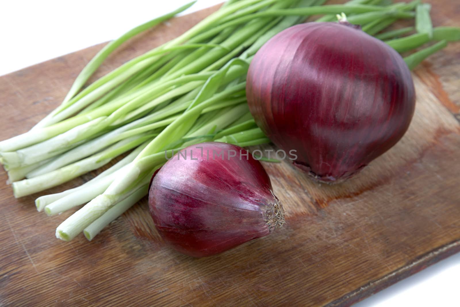 bulb and green onion a chopping board