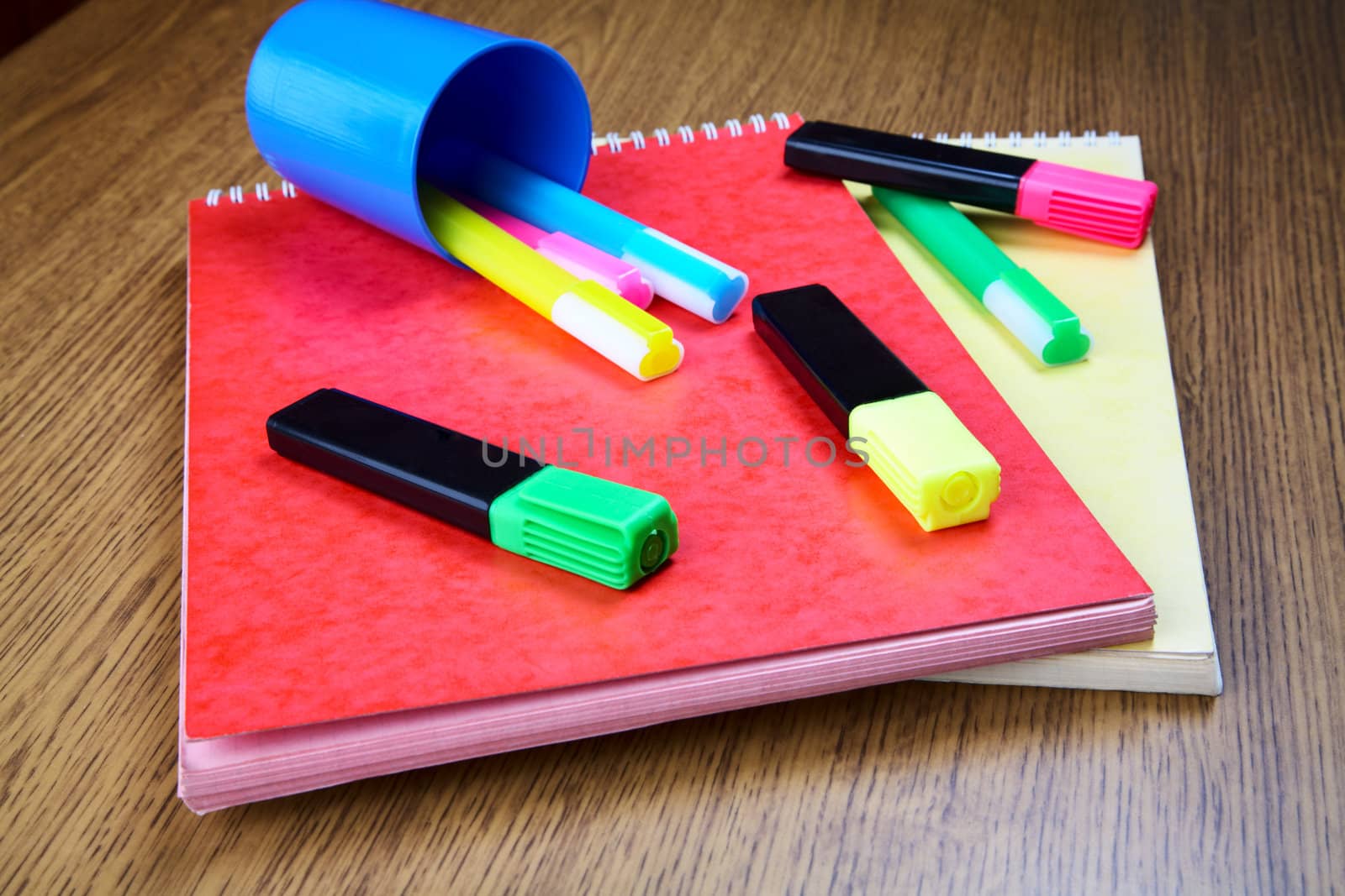 Business still-life with notebooks and markers on a table