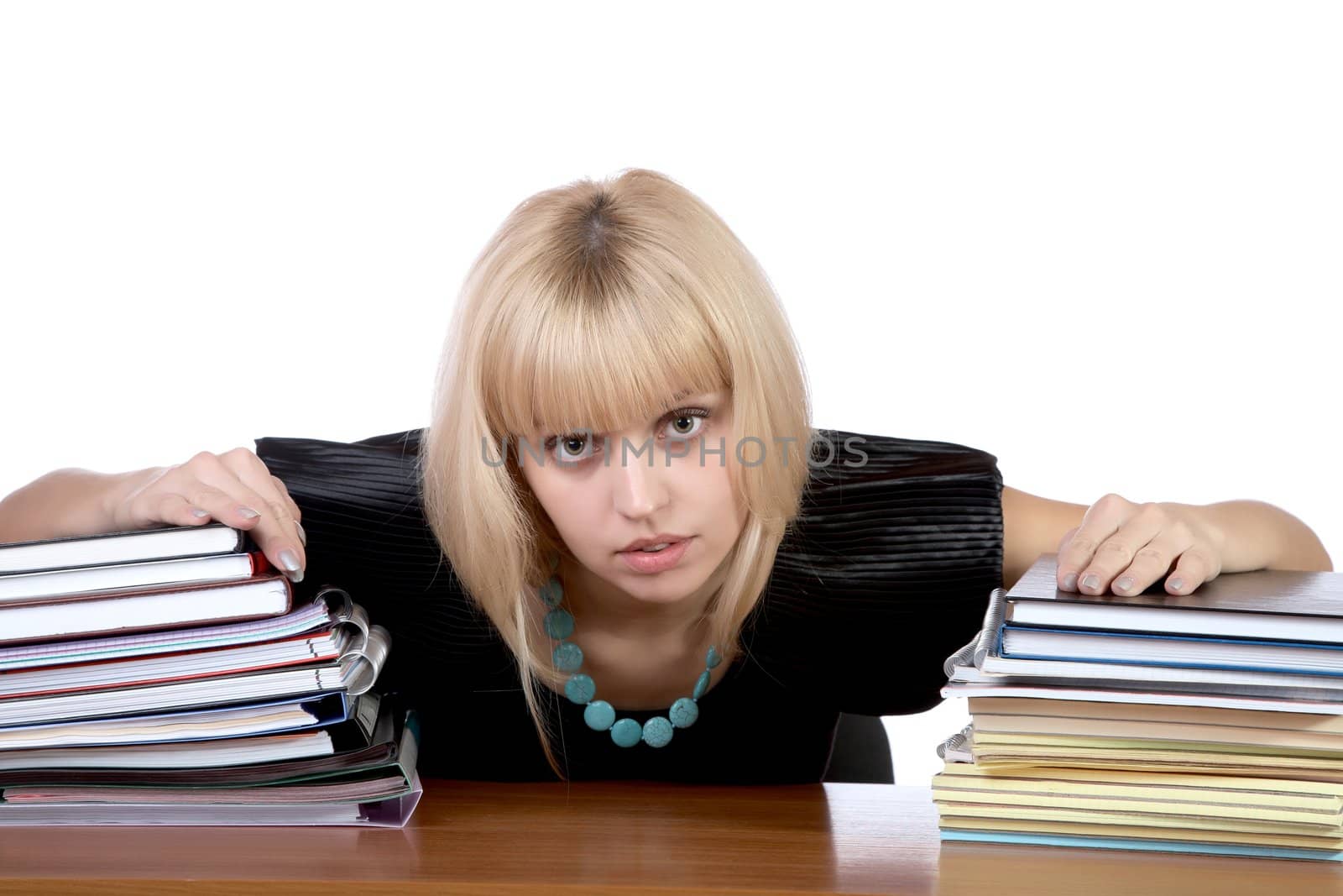 girl with two piles of writing-books and notebooks on a white background