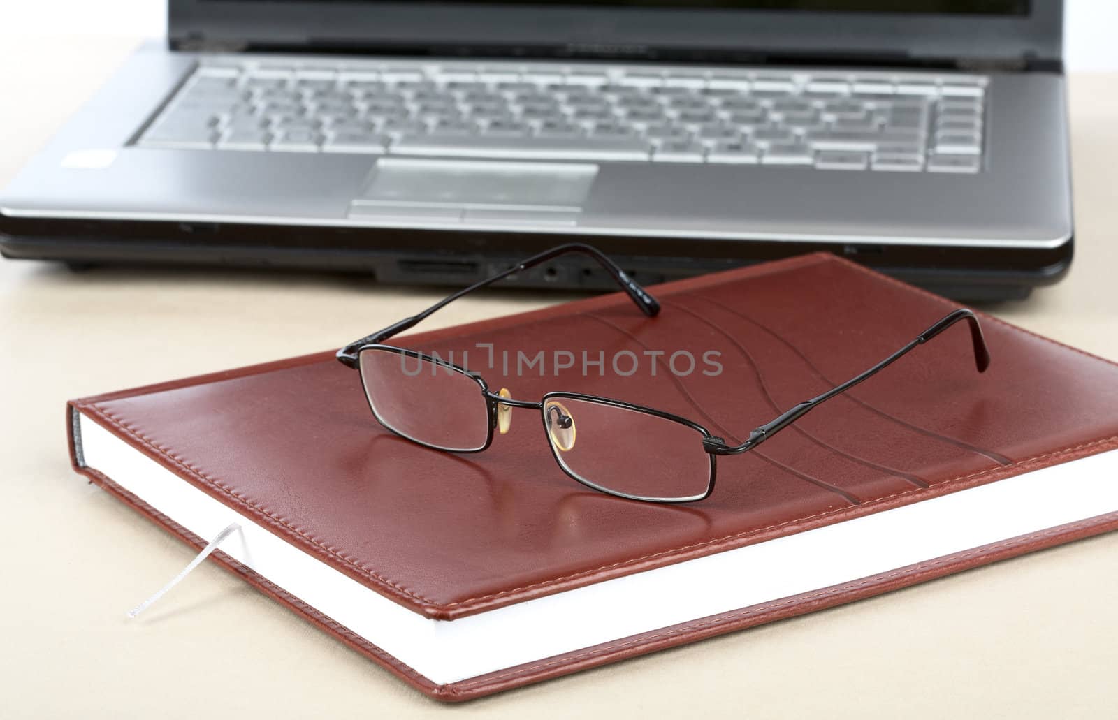 Organizer glasses and notebook on a desk