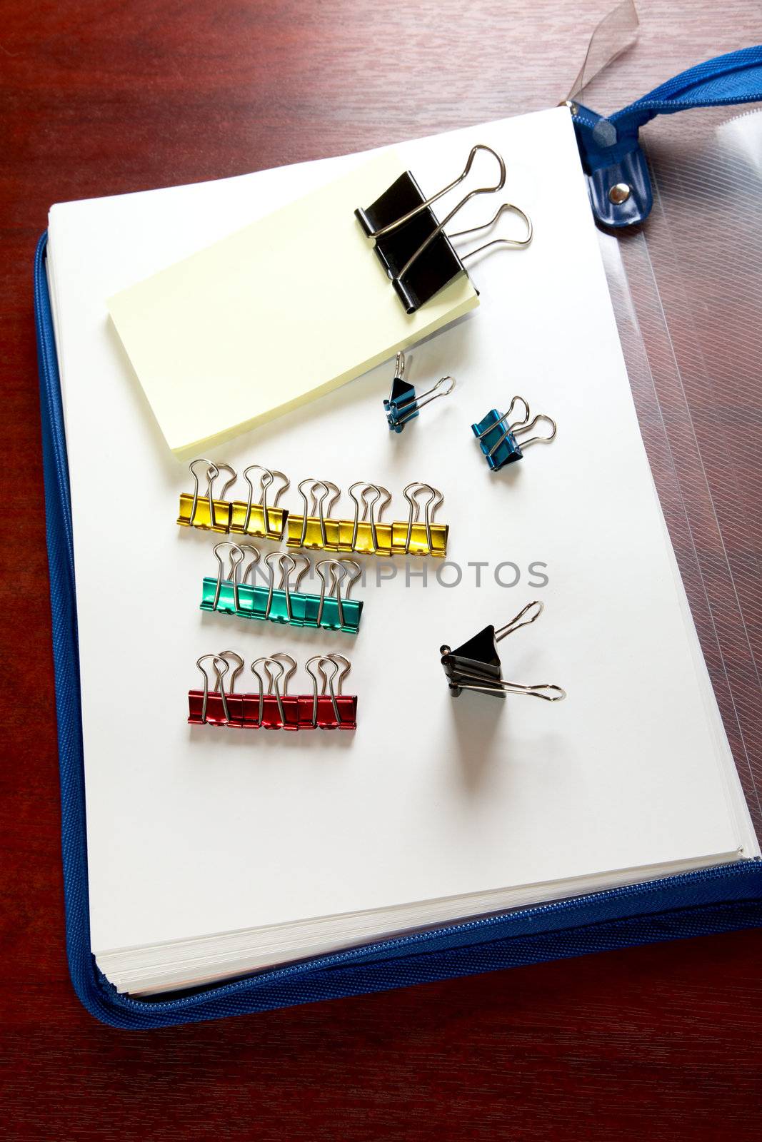 folder sheets and paper clips on a desk
