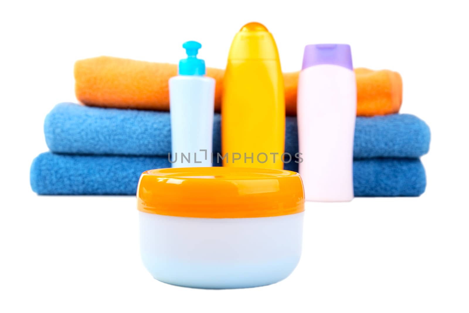 Terry towels and tubes with cosmetics isolated on a white background