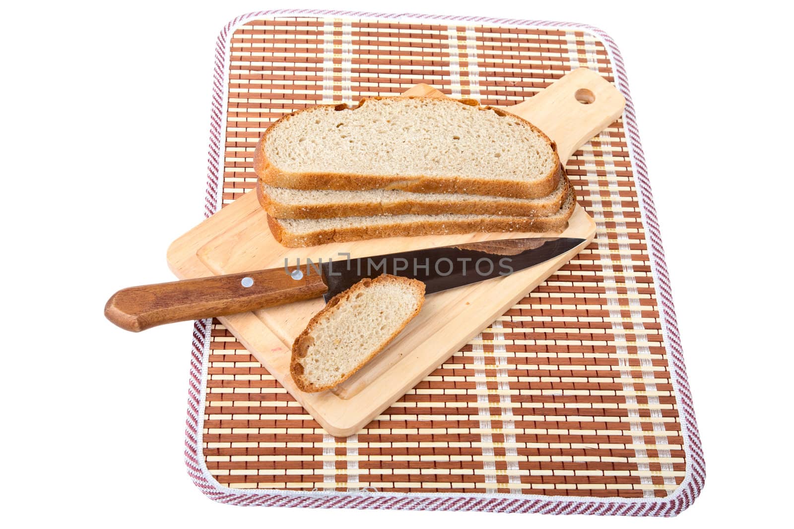 Slices of bread  knife chopping board isolated on a white background