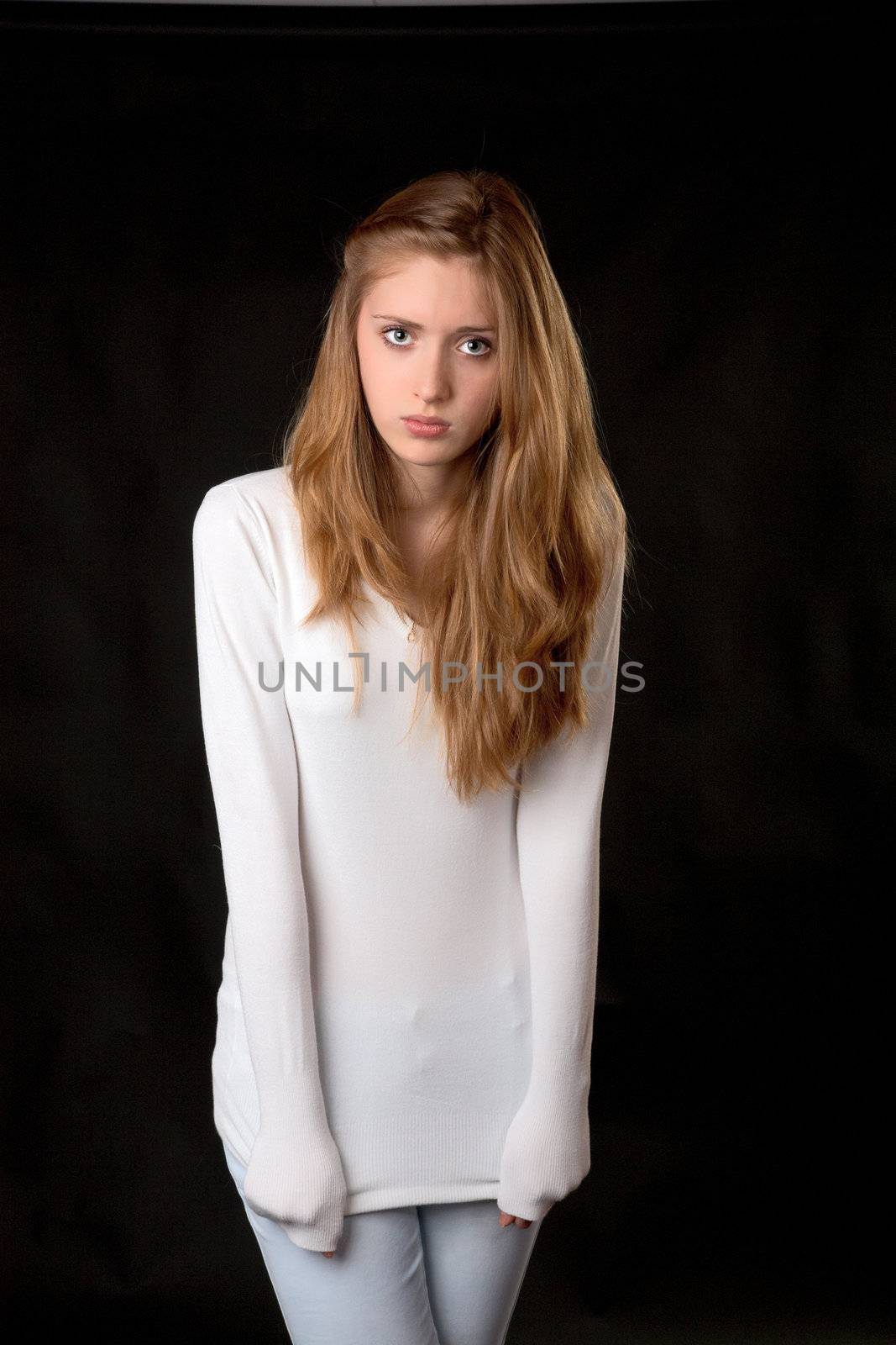 The girl in  white sweater on a black background