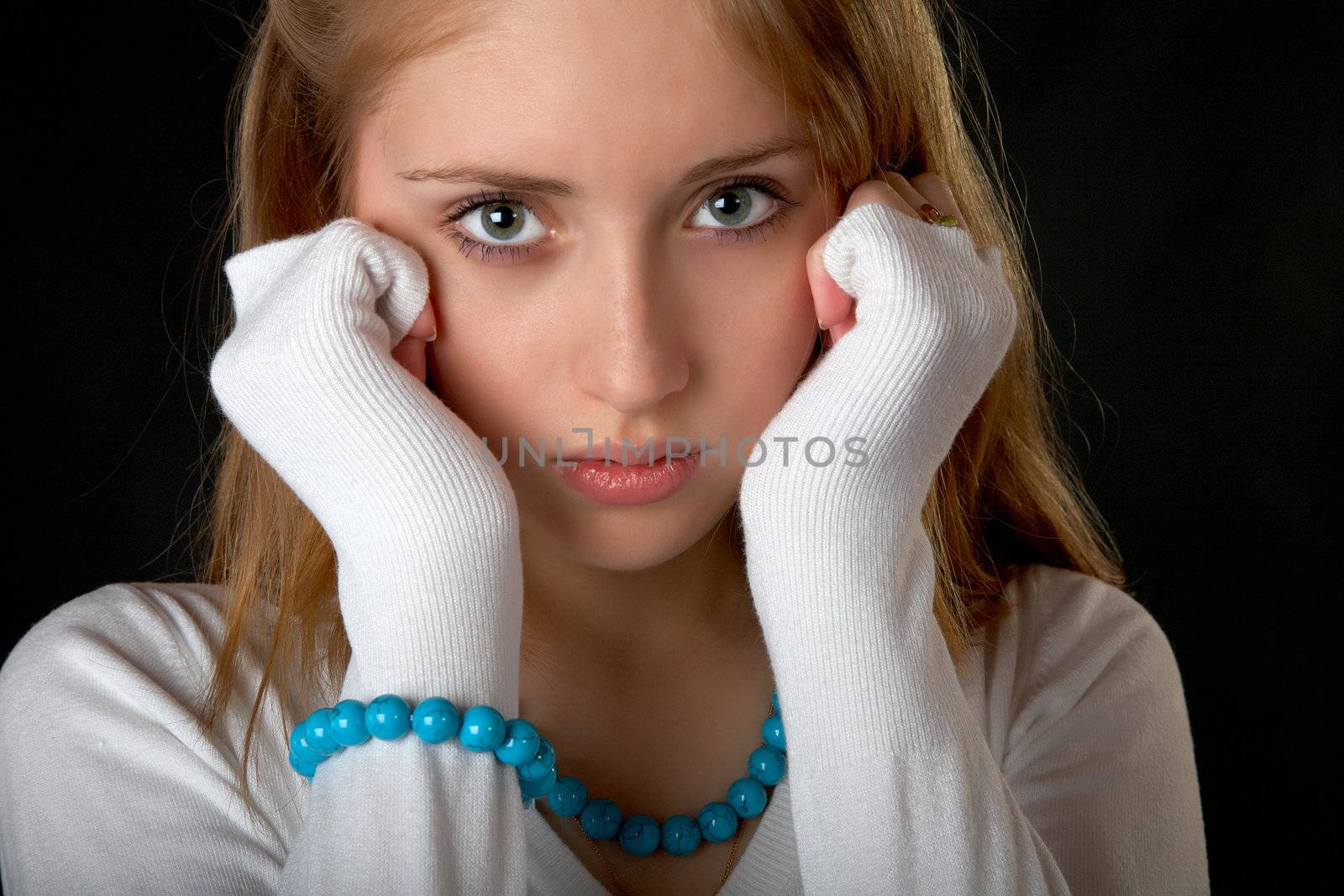 The girl with  beads and bracelet on  black background