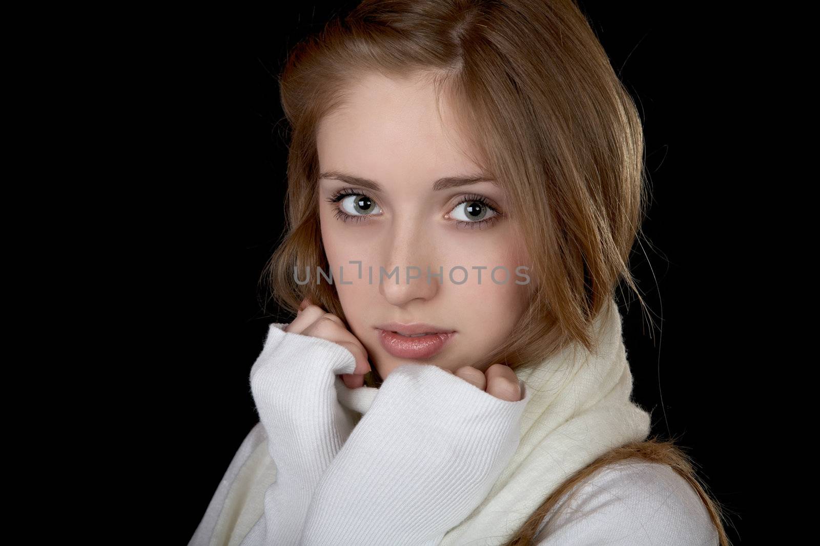 The girl in  white sweater on a black background