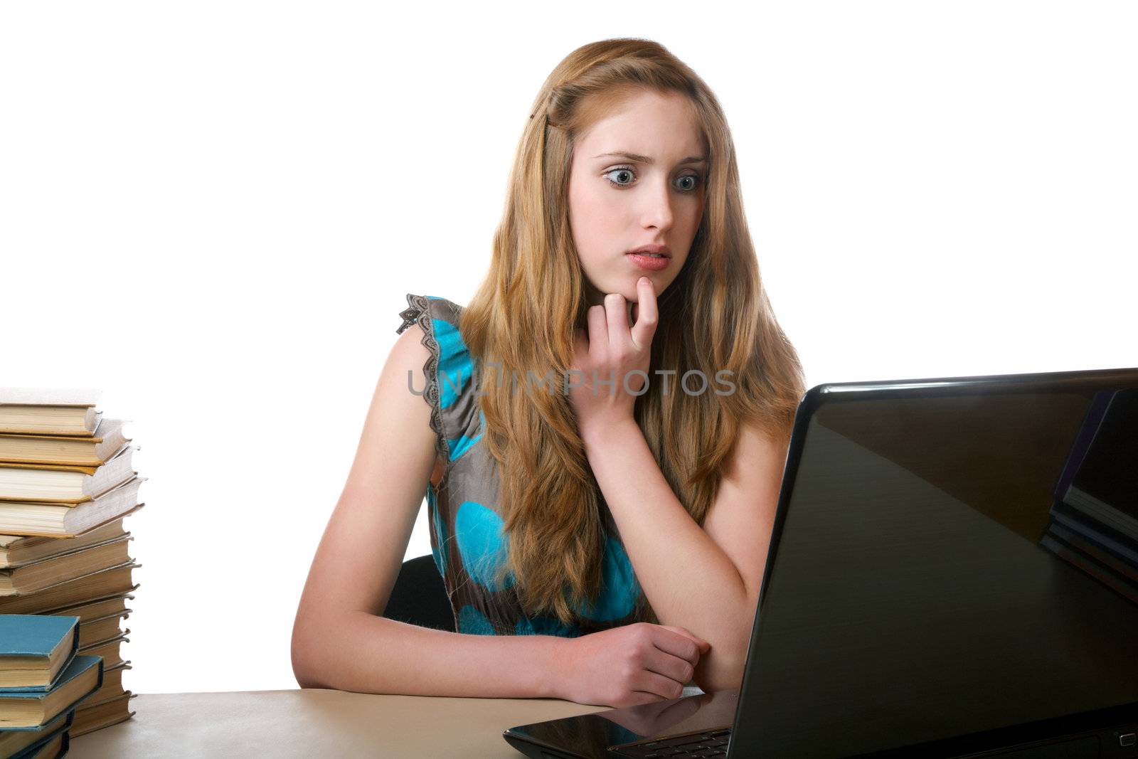 girl with surprise looks at the laptop screen