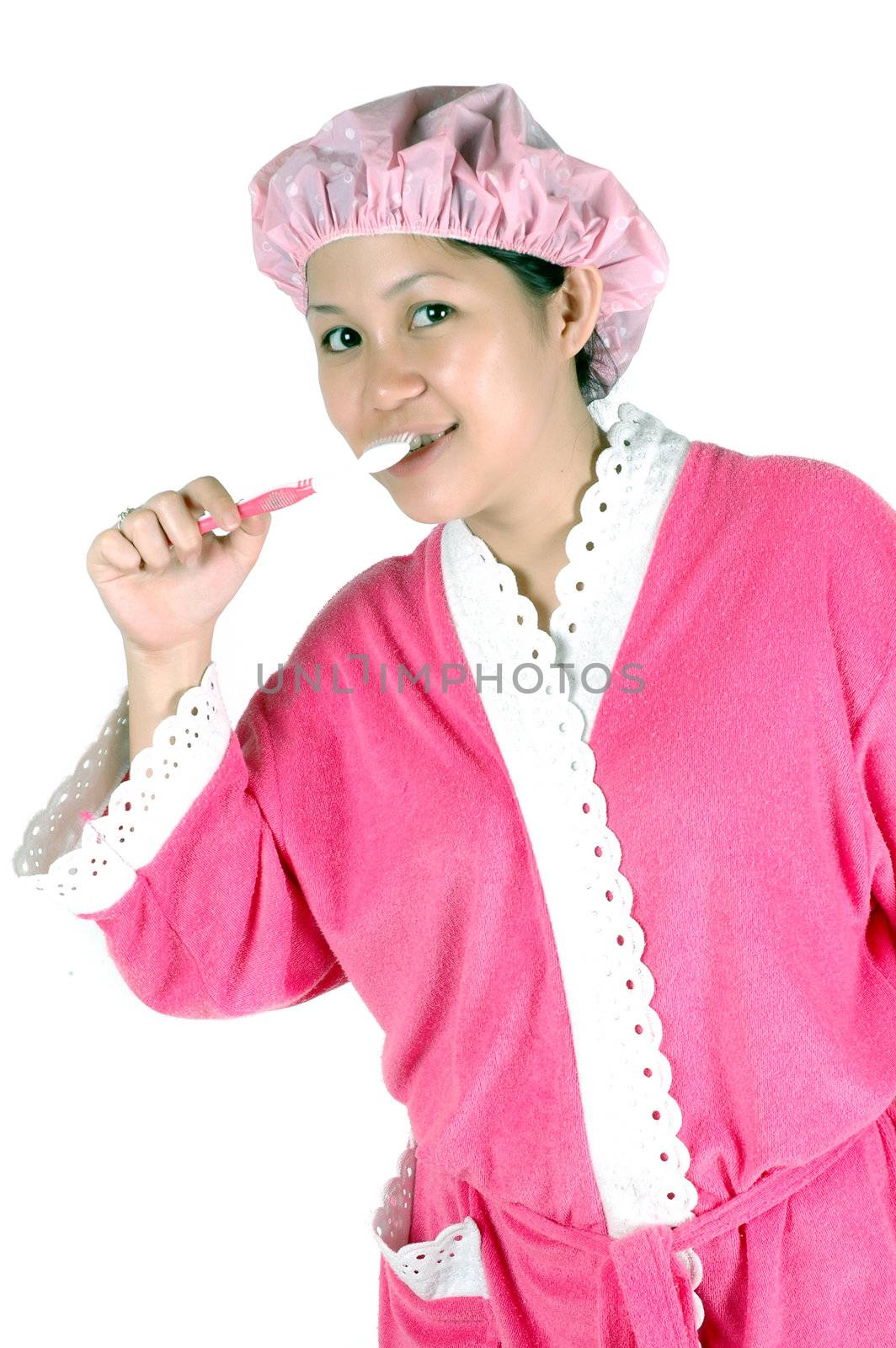 young woman brushing her teeth isolated on white background