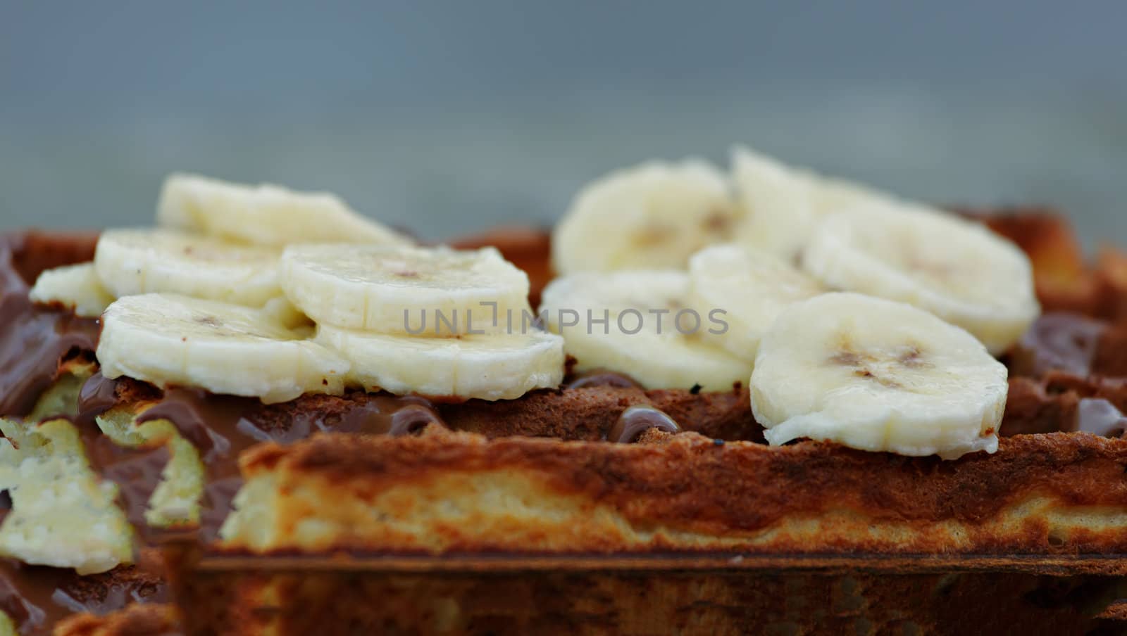 Delicious waffles with fruits and chocolate