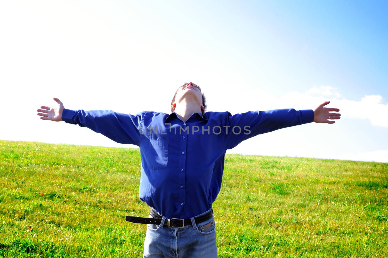 man on field rising up his hands