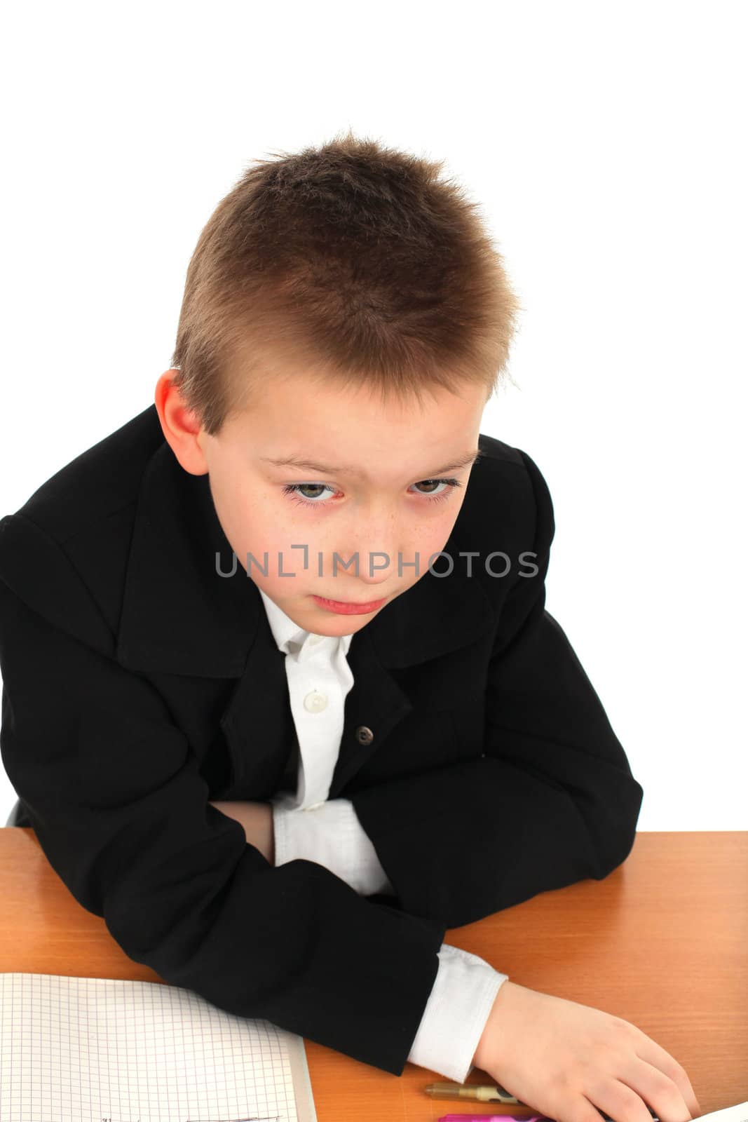 sad schoolboy on the table