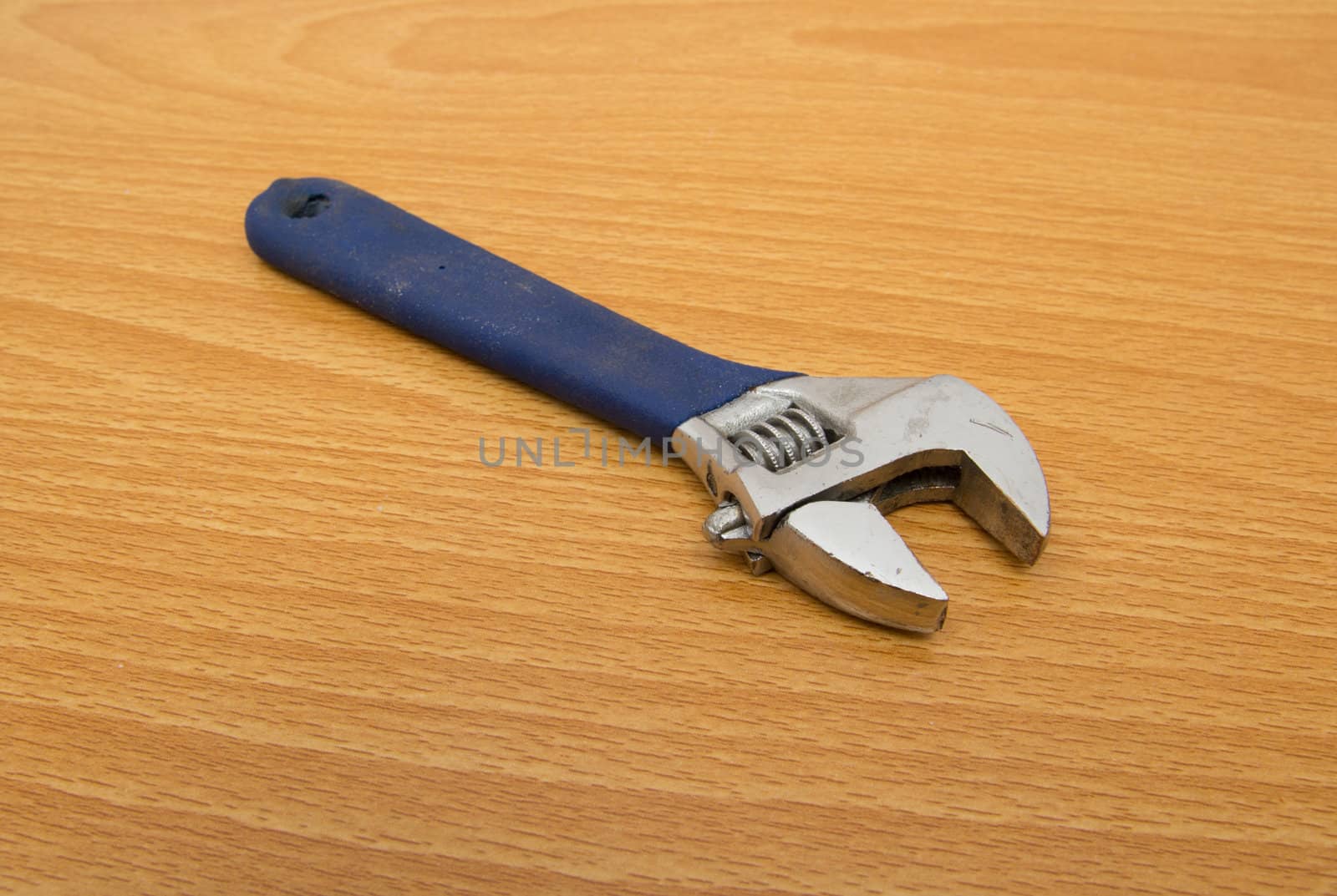 blue monkey wrench on a wooden background