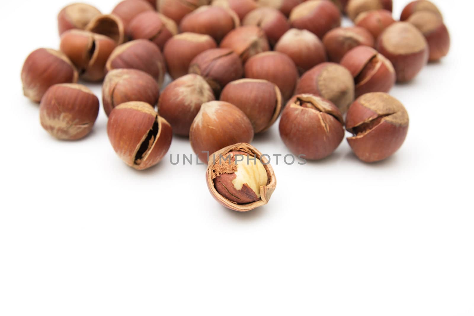 Heap of hazelnuts isolated on white background 