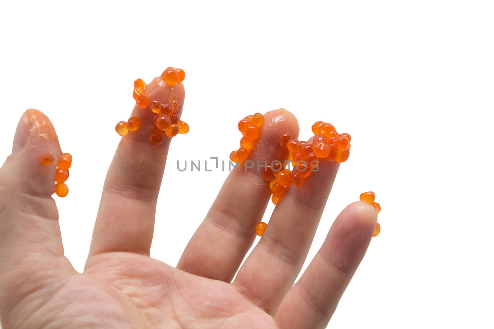 hand in red caviar on white background