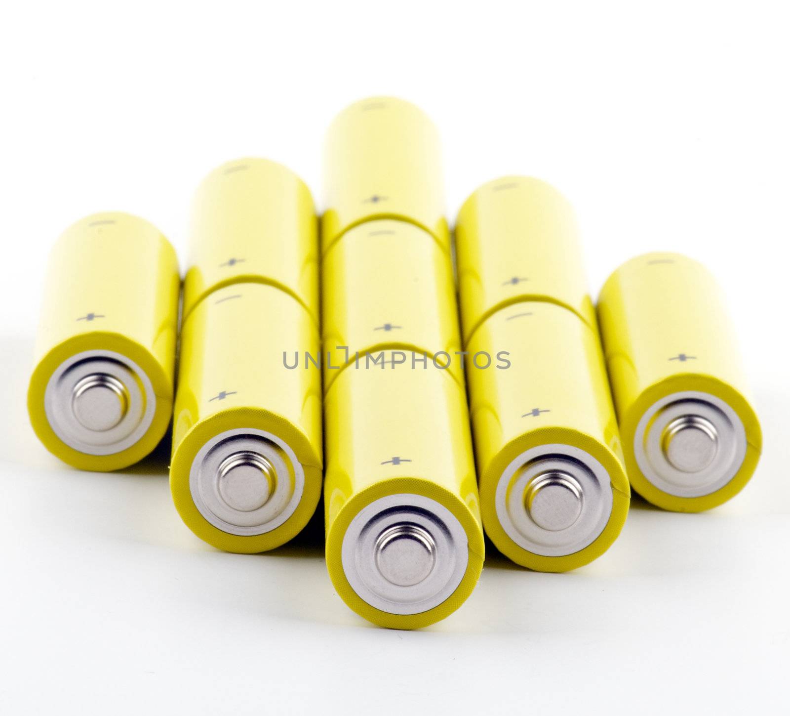 Arrangement of colorful yellow Batteries isolated on white background