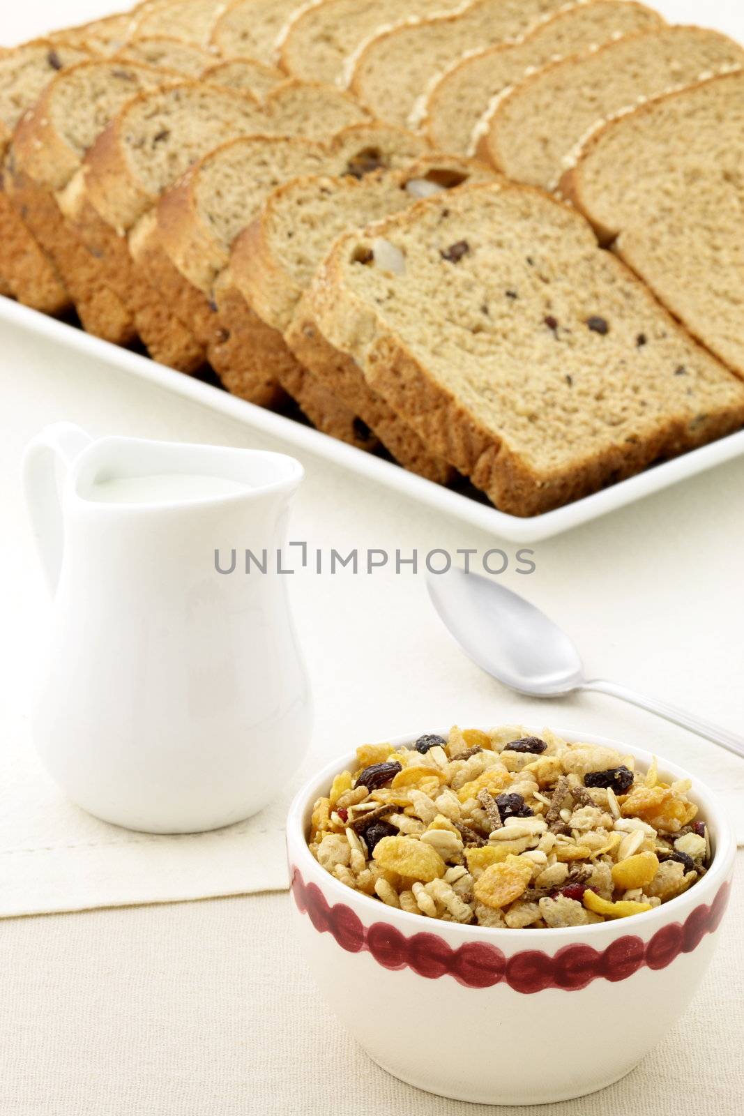 delicious breakfast with whole grain bread,milk and a healthy bowl of granola cereal.
