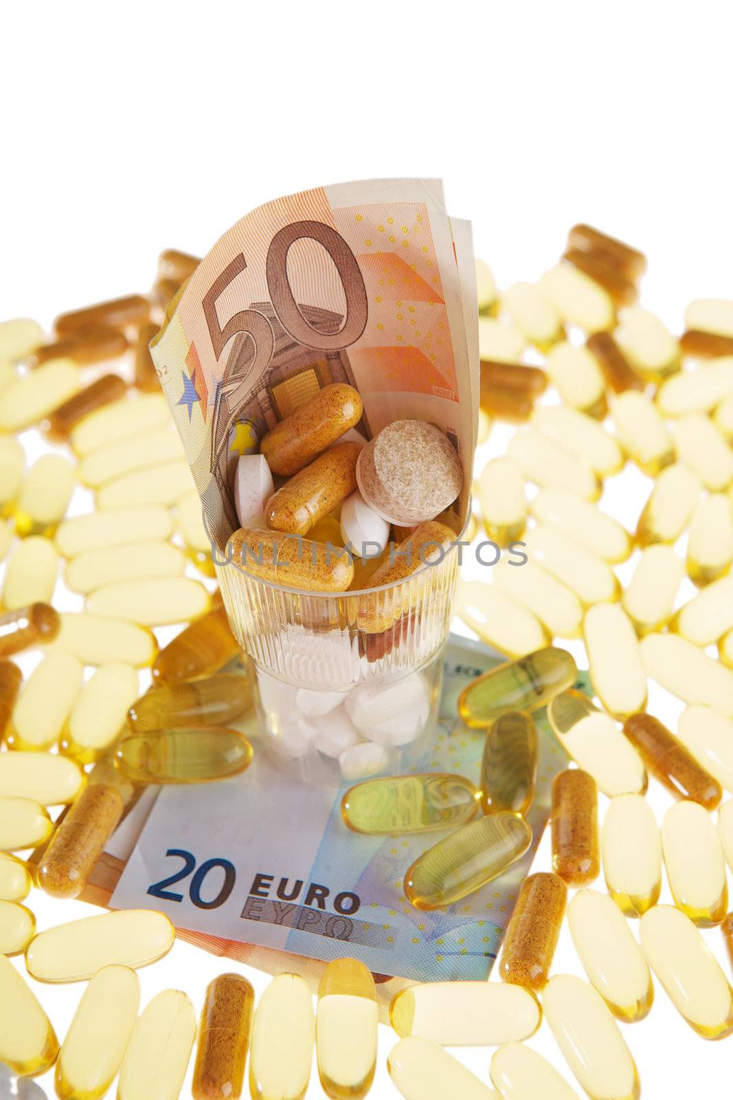 Pills and the euro on a white background