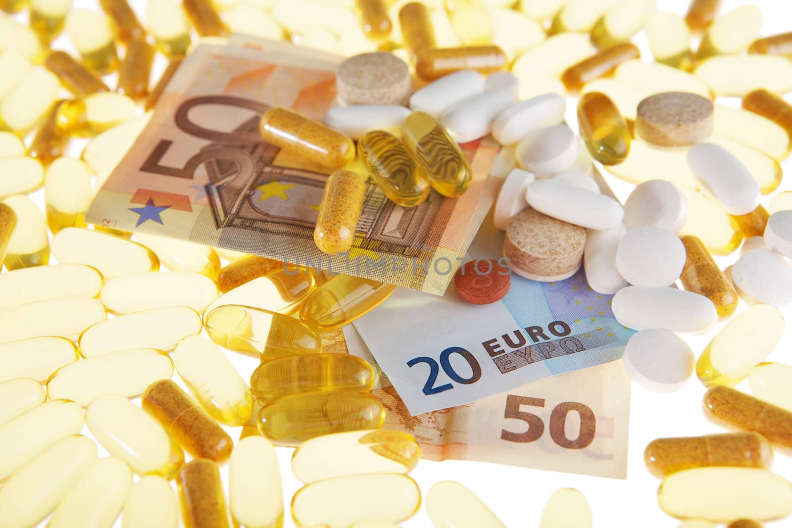 Pills and the euro on a white background