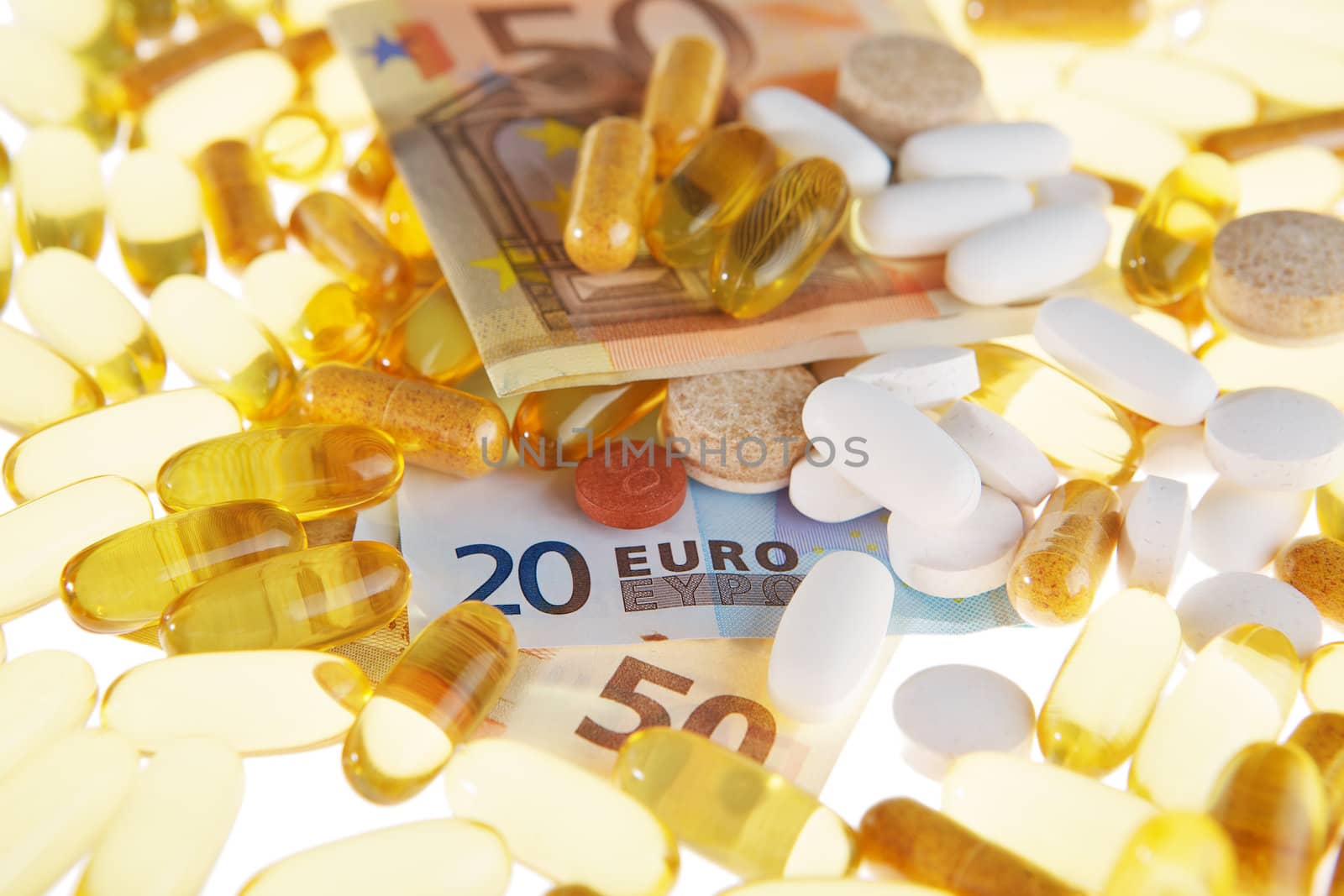 Pills and the euro on a white background