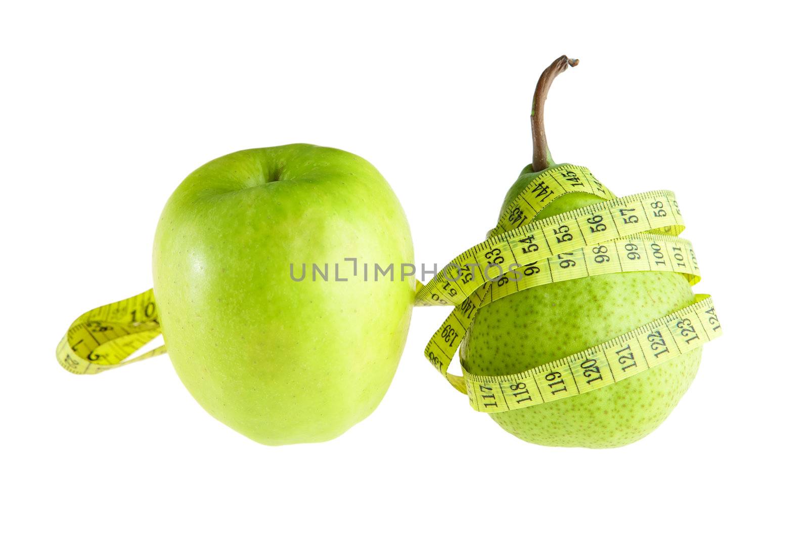 Ripe green pear and apple with measuring tape