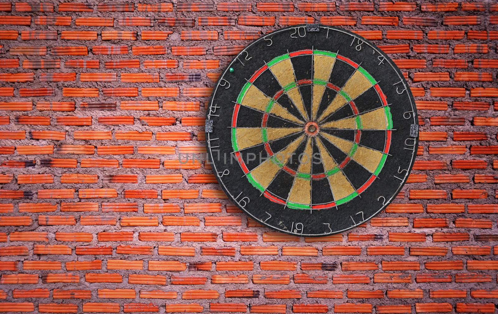 Dartboard on brick wall