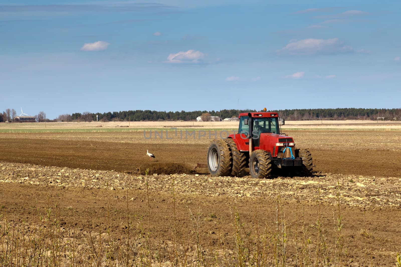 tractors working in the field in early spring