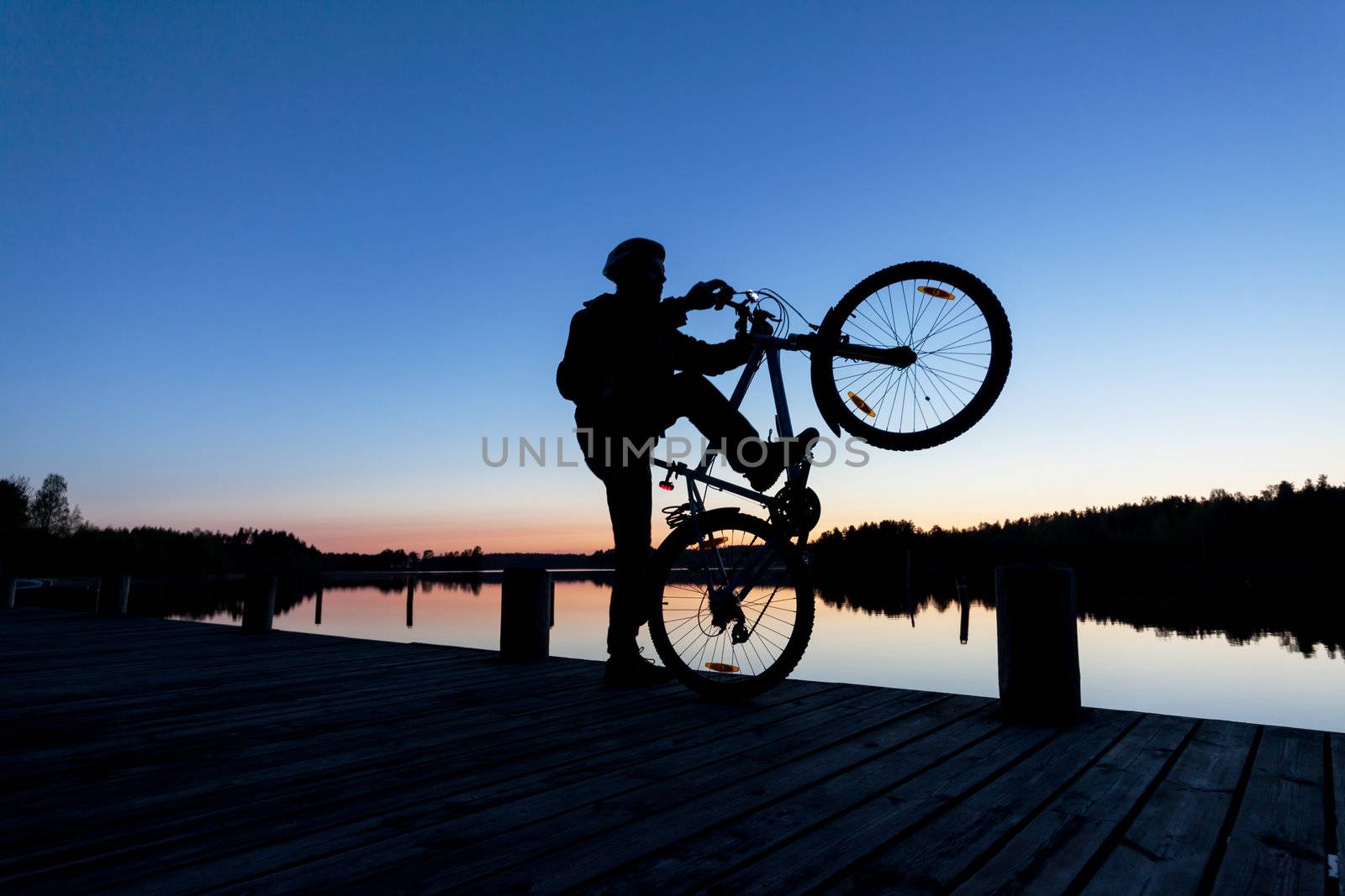 Silhouette of a Cyclist on the background of the Sunset Sky