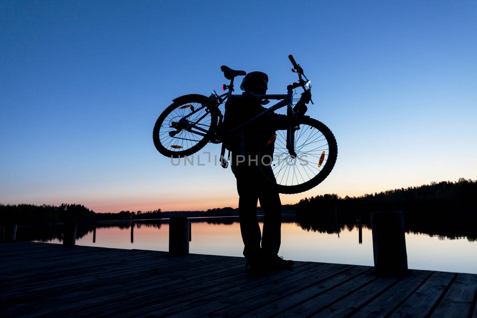 Silhouette of a Cyclist on the Sunset Sky by Discovod
