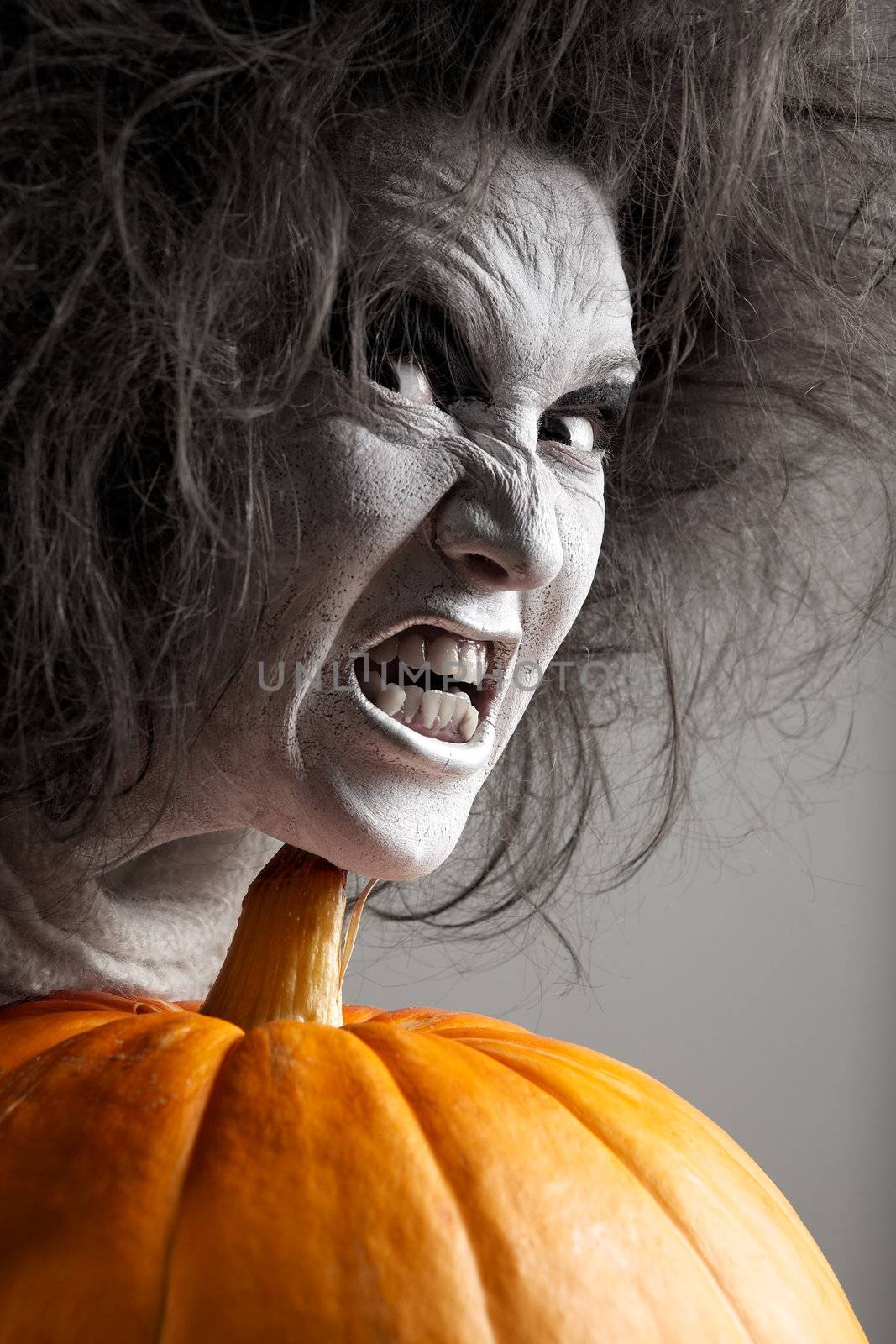 Woman with a bleached face and pumpkin. Halloween theme.