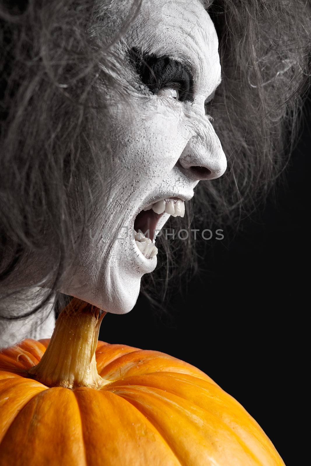 Woman with a bleached face and pumpkin. Halloween theme.